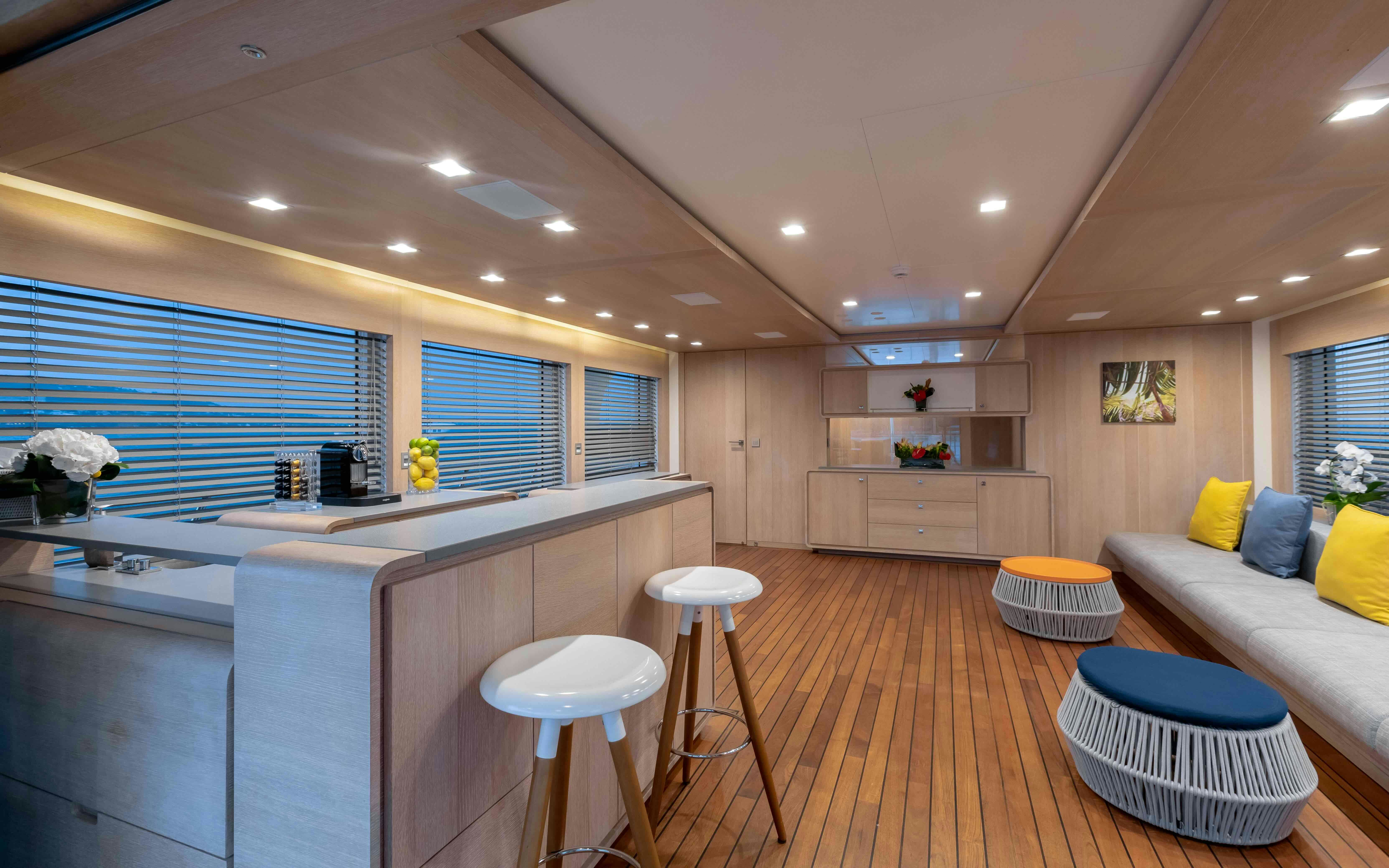 a modern looking kitchen with a large island and a large window aboard ROBBIE BOBBY Yacht for Sale