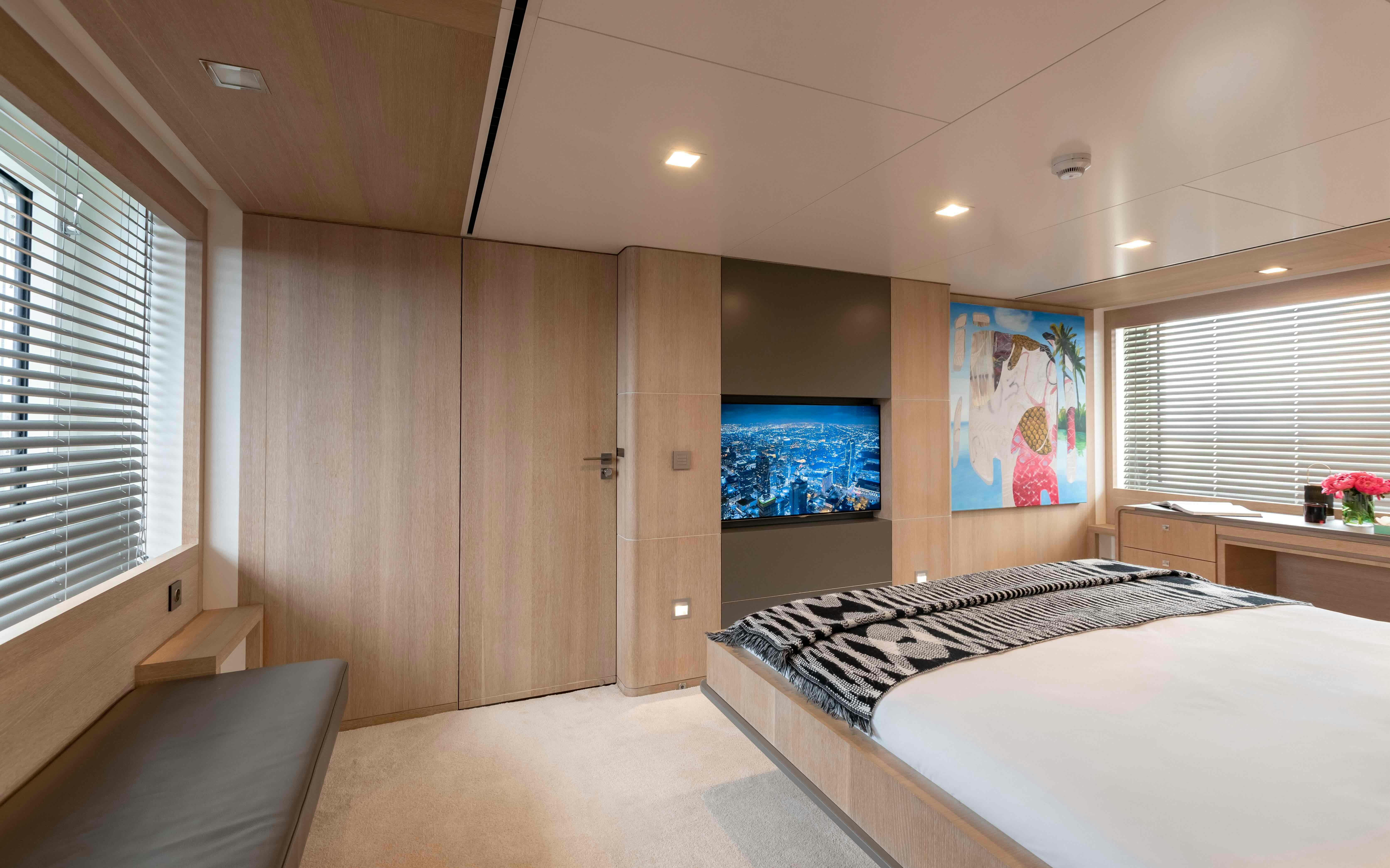 a bedroom with a bed and a tv aboard ROBBIE BOBBY Yacht for Sale