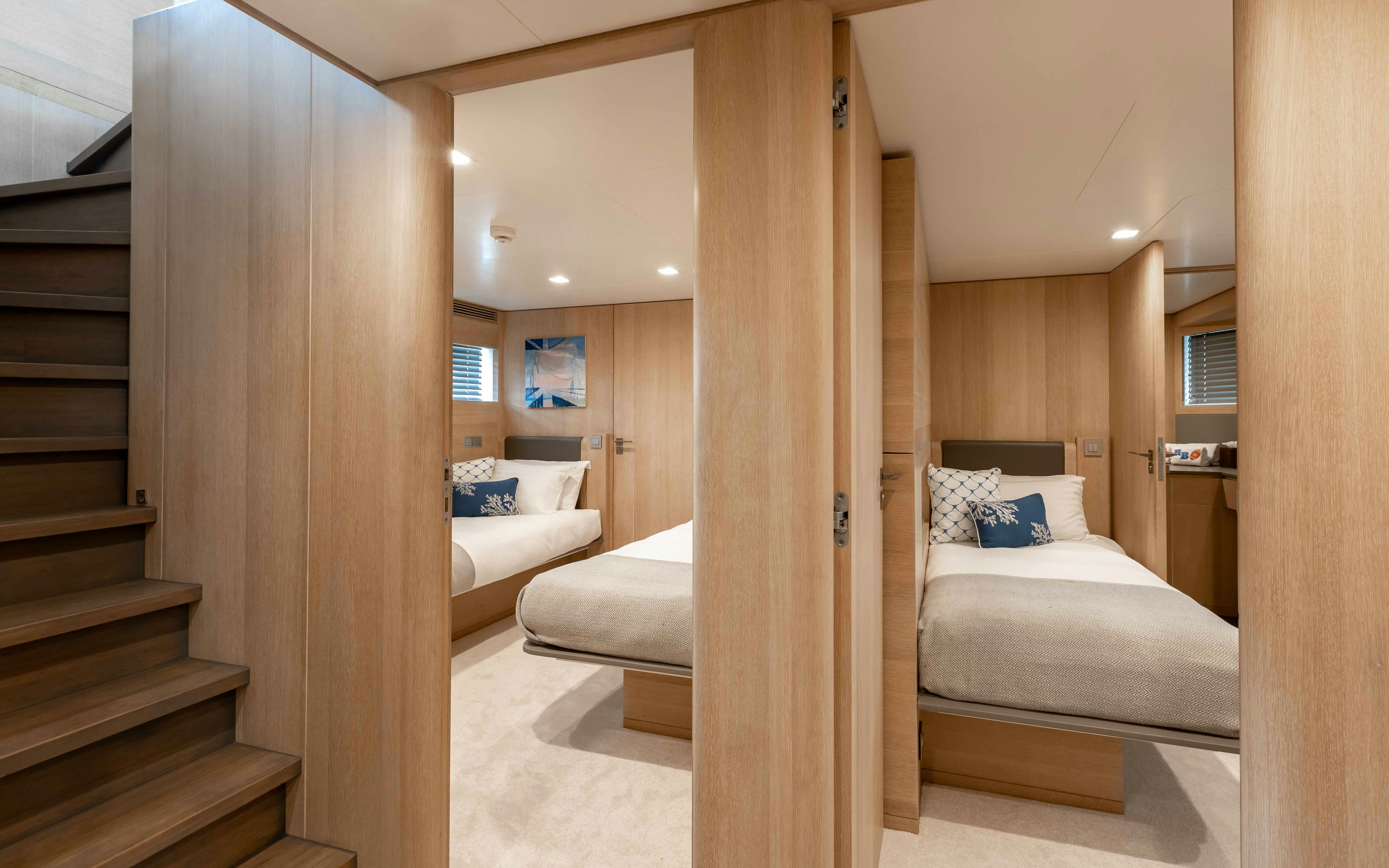 a room with a bed and a staircase aboard ROBBIE BOBBY Yacht for Sale