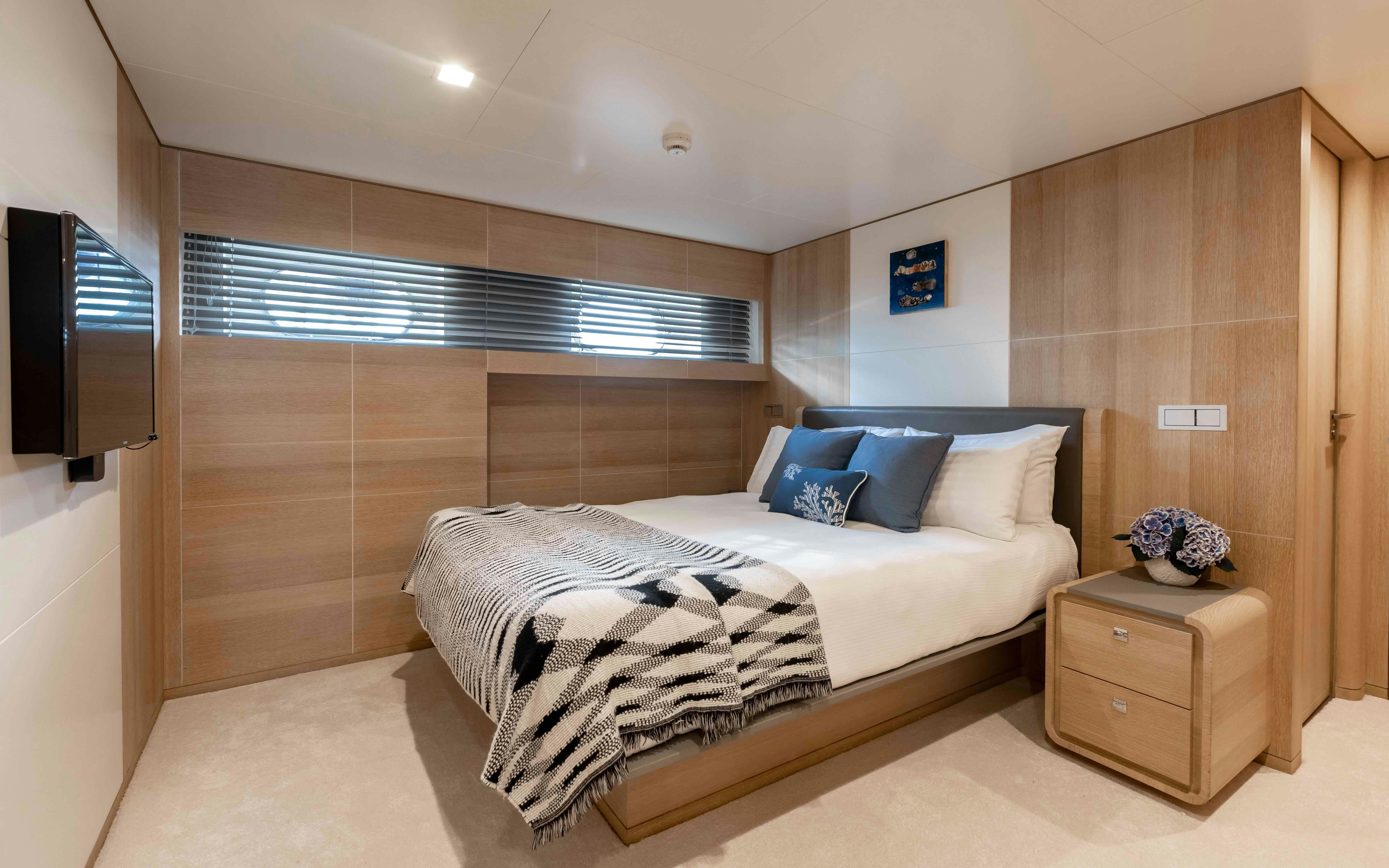 a bedroom with a bed and a television aboard ROBBIE BOBBY Yacht for Sale
