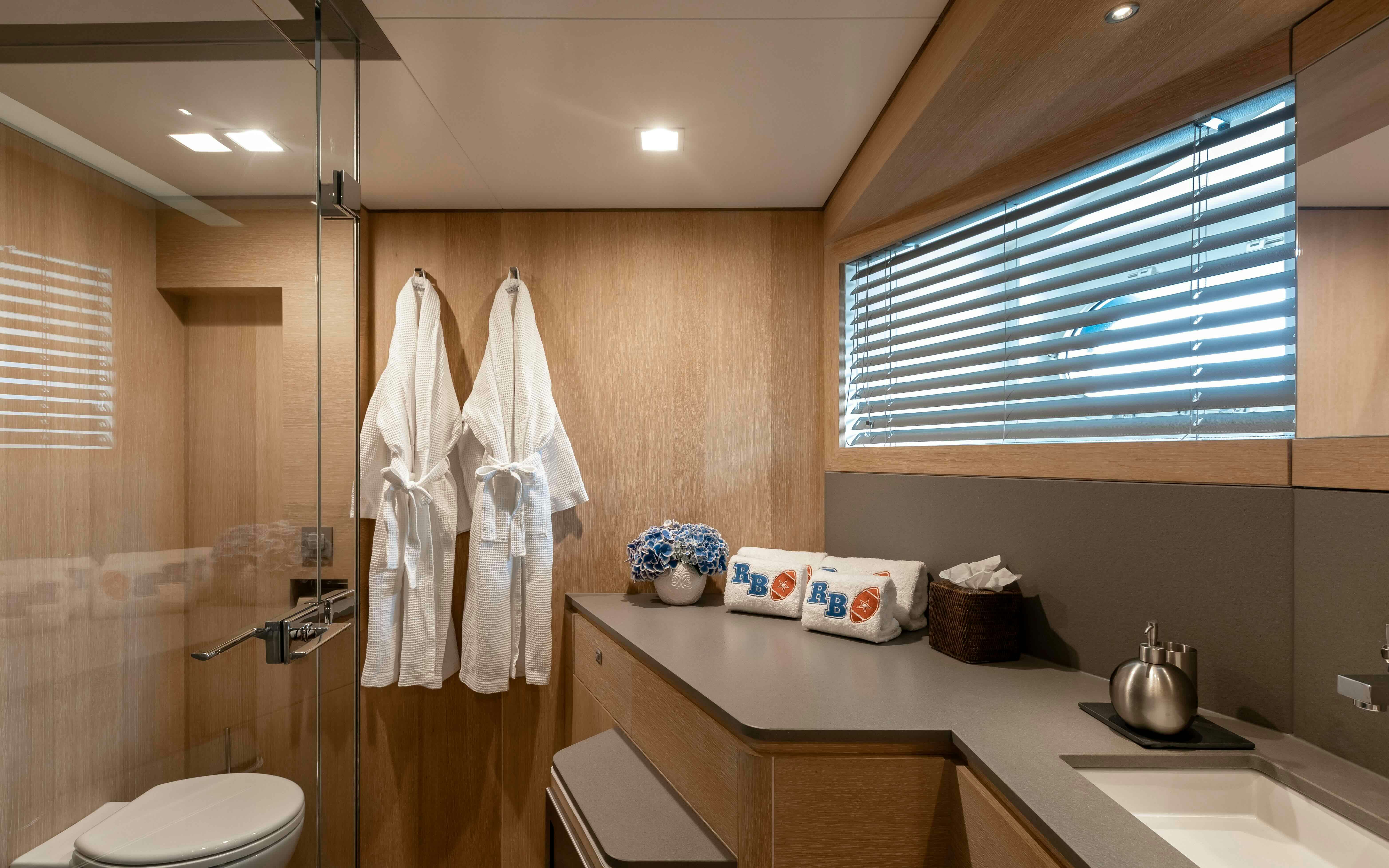 a bathroom with a countertop sink and a toilet aboard ROBBIE BOBBY Yacht for Sale