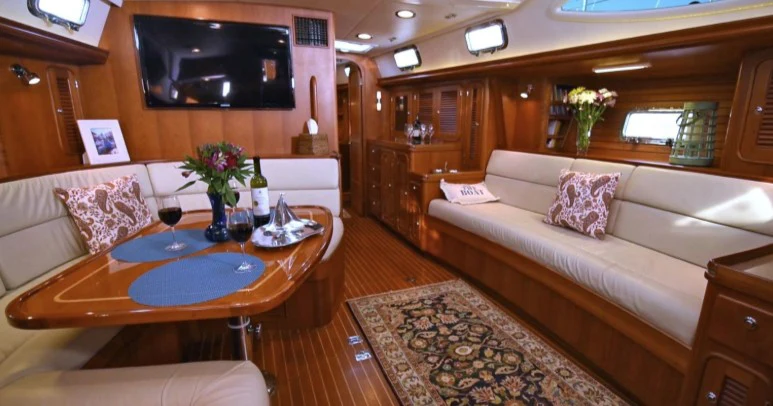 a living room with a couch and a table aboard SAUCY FOX Yacht for Sale