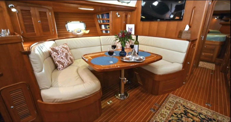 a living room with a couch and a table aboard SAUCY FOX Yacht for Sale