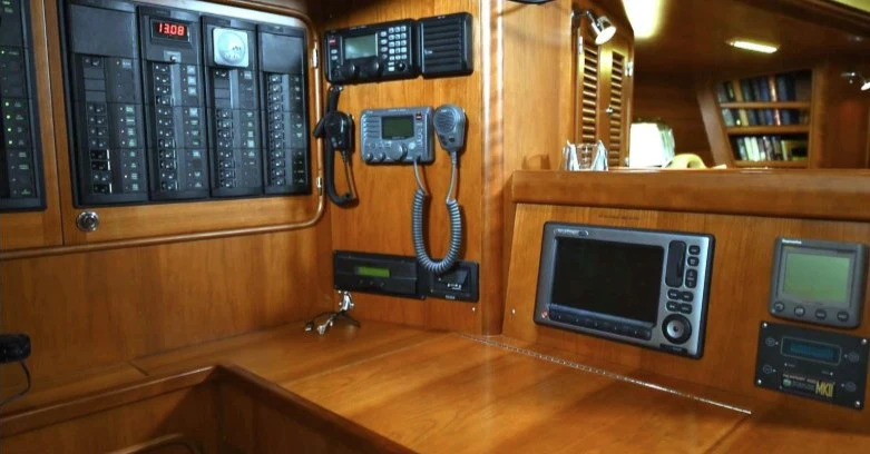 a group of electronic devices on a wooden table aboard SAUCY FOX Yacht for Sale