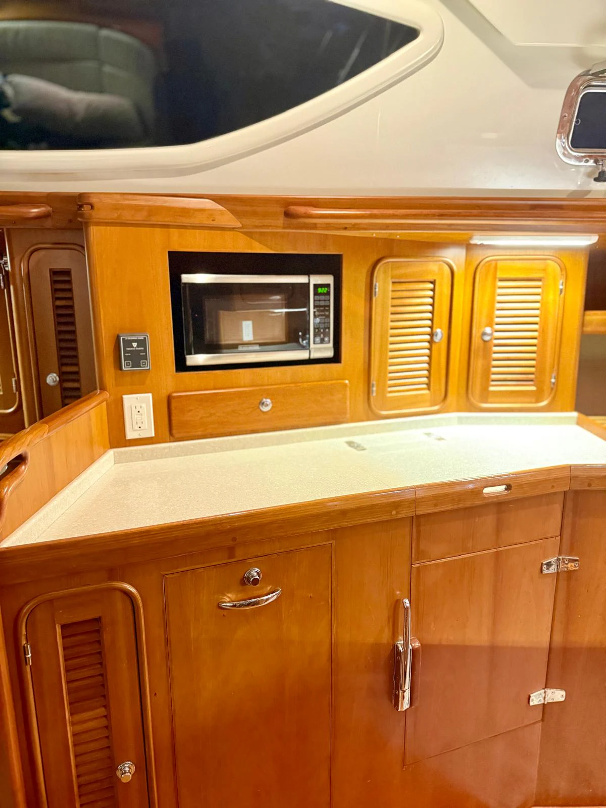 a kitchen with wooden cabinets aboard SAUCY FOX Yacht for Sale