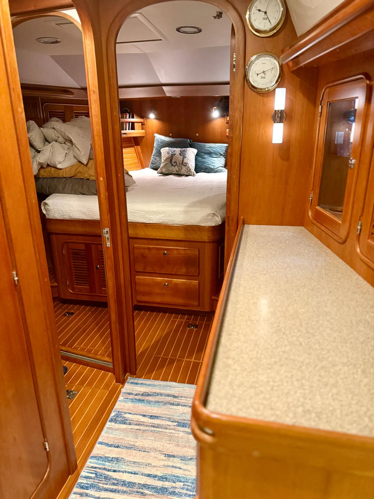 a bedroom with a bed and a mirror aboard SAUCY FOX Yacht for Sale