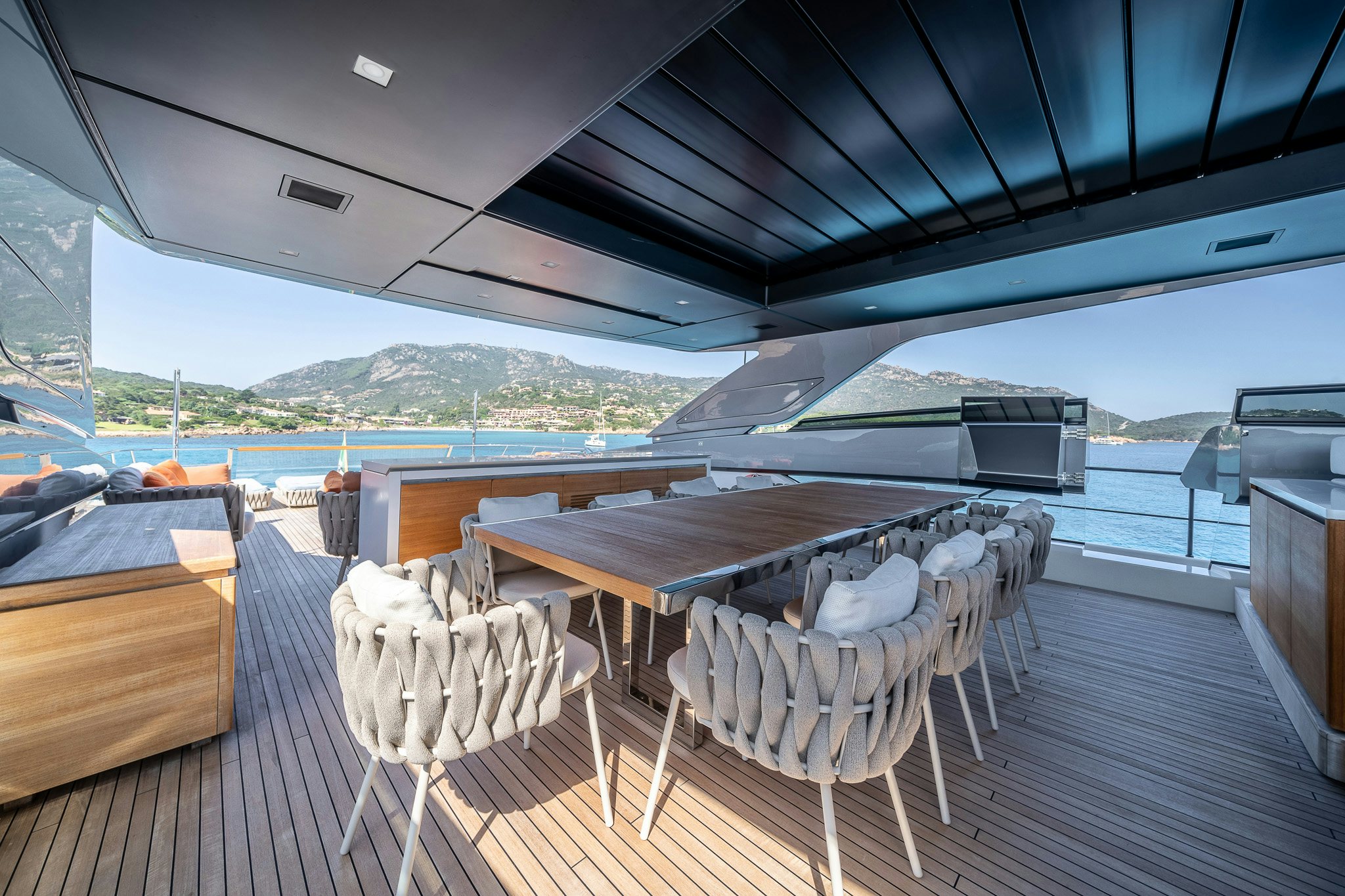 a deck with a deck and a large ship in the water aboard BLUE ANGEL Yacht for Sale