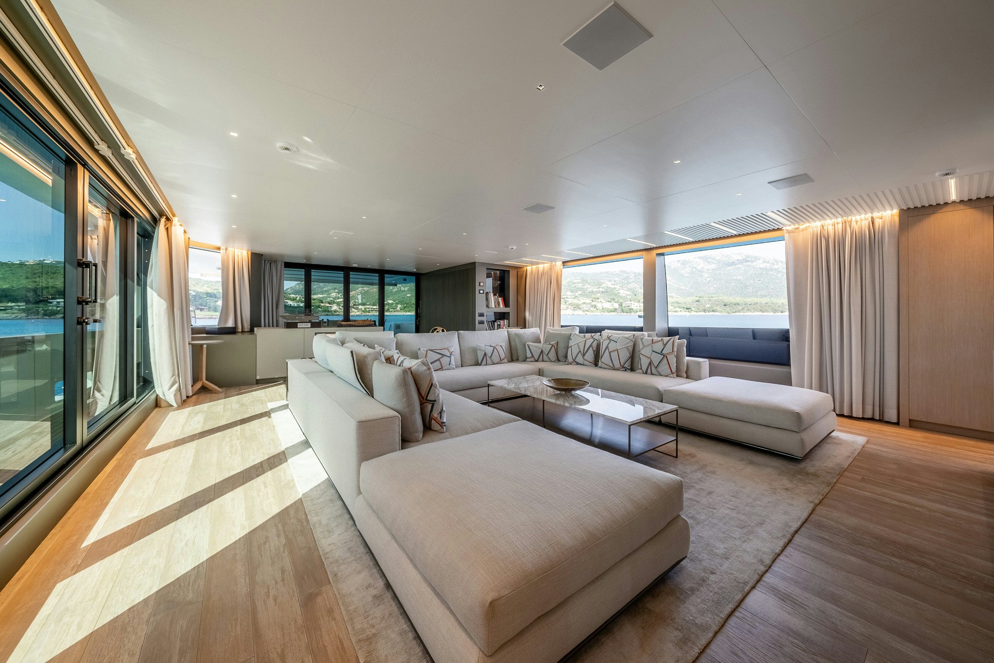 a living room with a large window aboard BLUE ANGEL Yacht for Sale