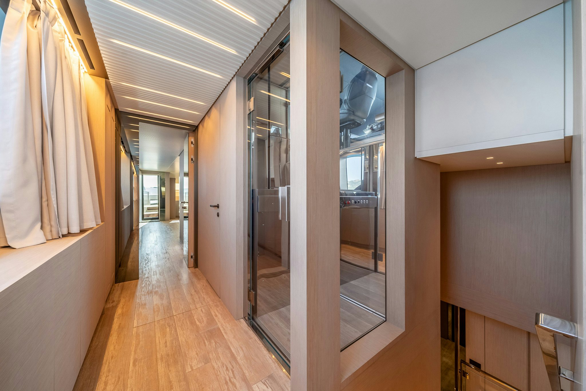 a hallway with glass doors aboard BLUE ANGEL Yacht for Sale
