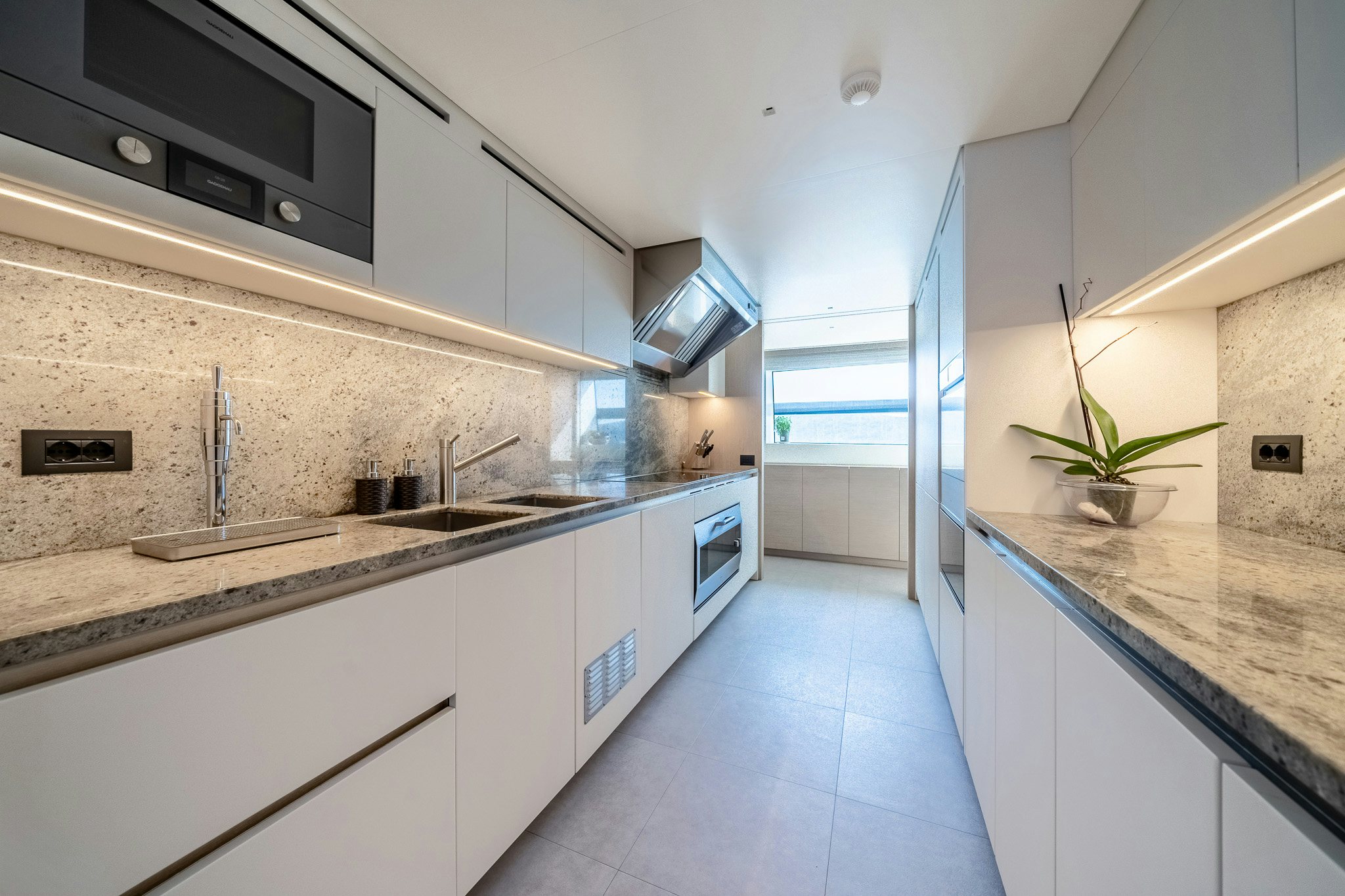 a kitchen with white cabinets aboard BLUE ANGEL Yacht for Sale