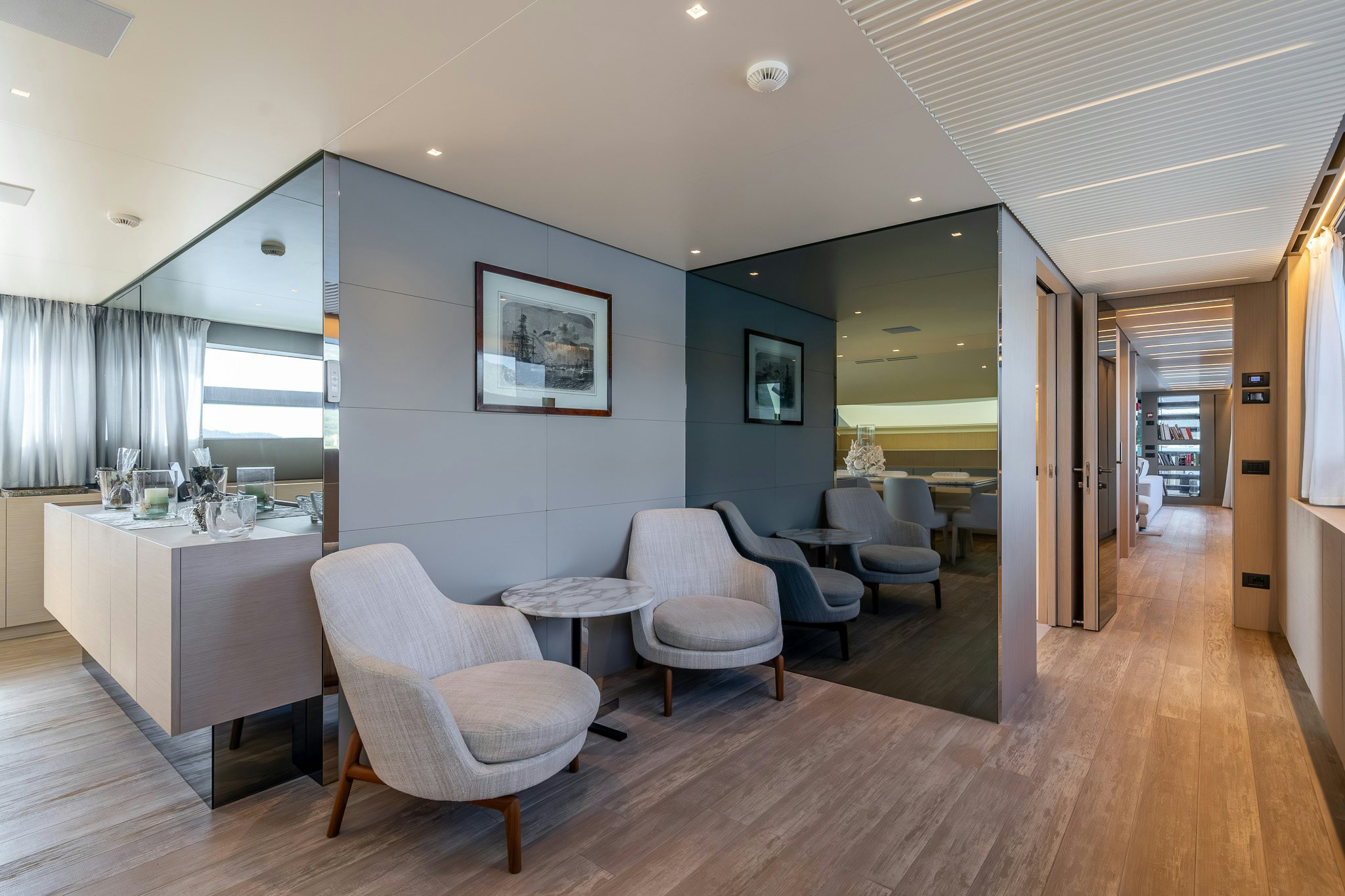 a room with a wood floor and chairs and a table aboard BLUE ANGEL Yacht for Sale