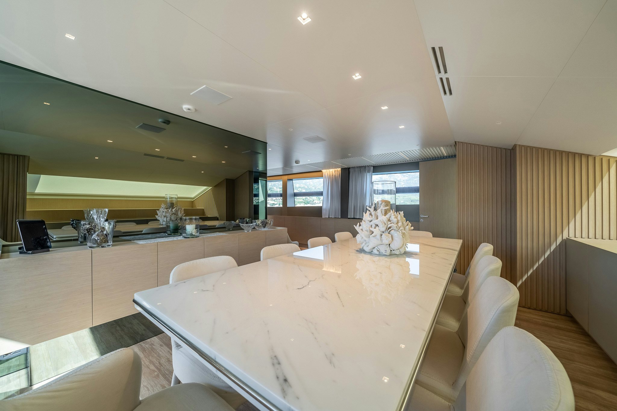 a large room with a table and chairs aboard BLUE ANGEL Yacht for Sale