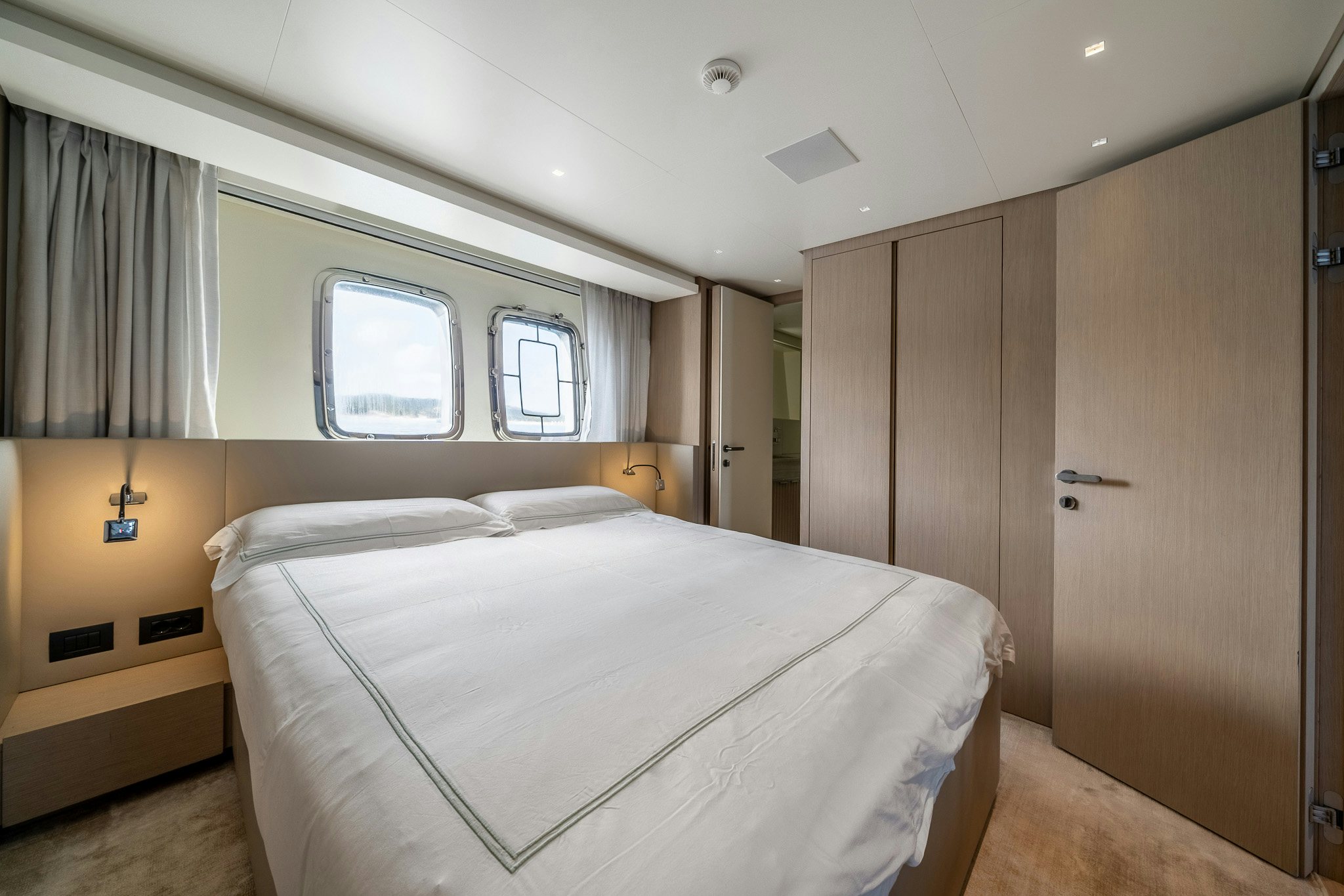 a room with a bed and a closet aboard BLUE ANGEL Yacht for Sale