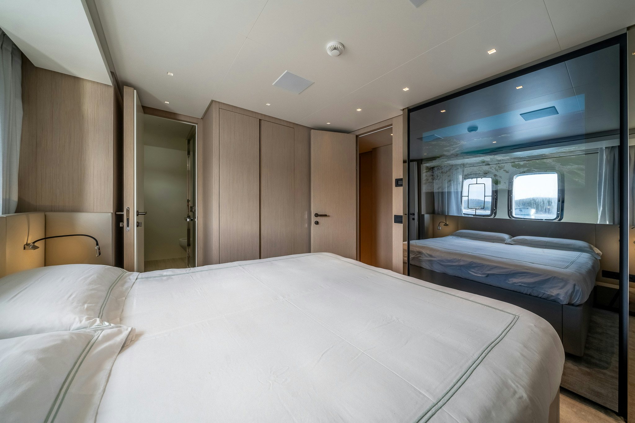 a room with a bed and a mirror aboard BLUE ANGEL Yacht for Sale