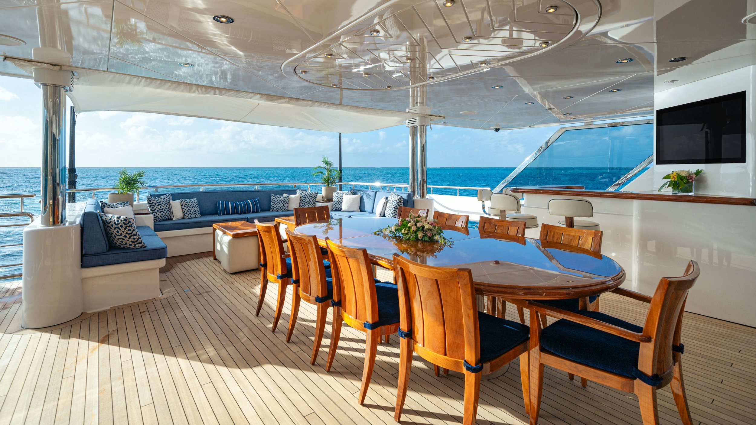 a large room with a table and chairs and a large window aboard CHASING DAYLIGHT Yacht for Charter