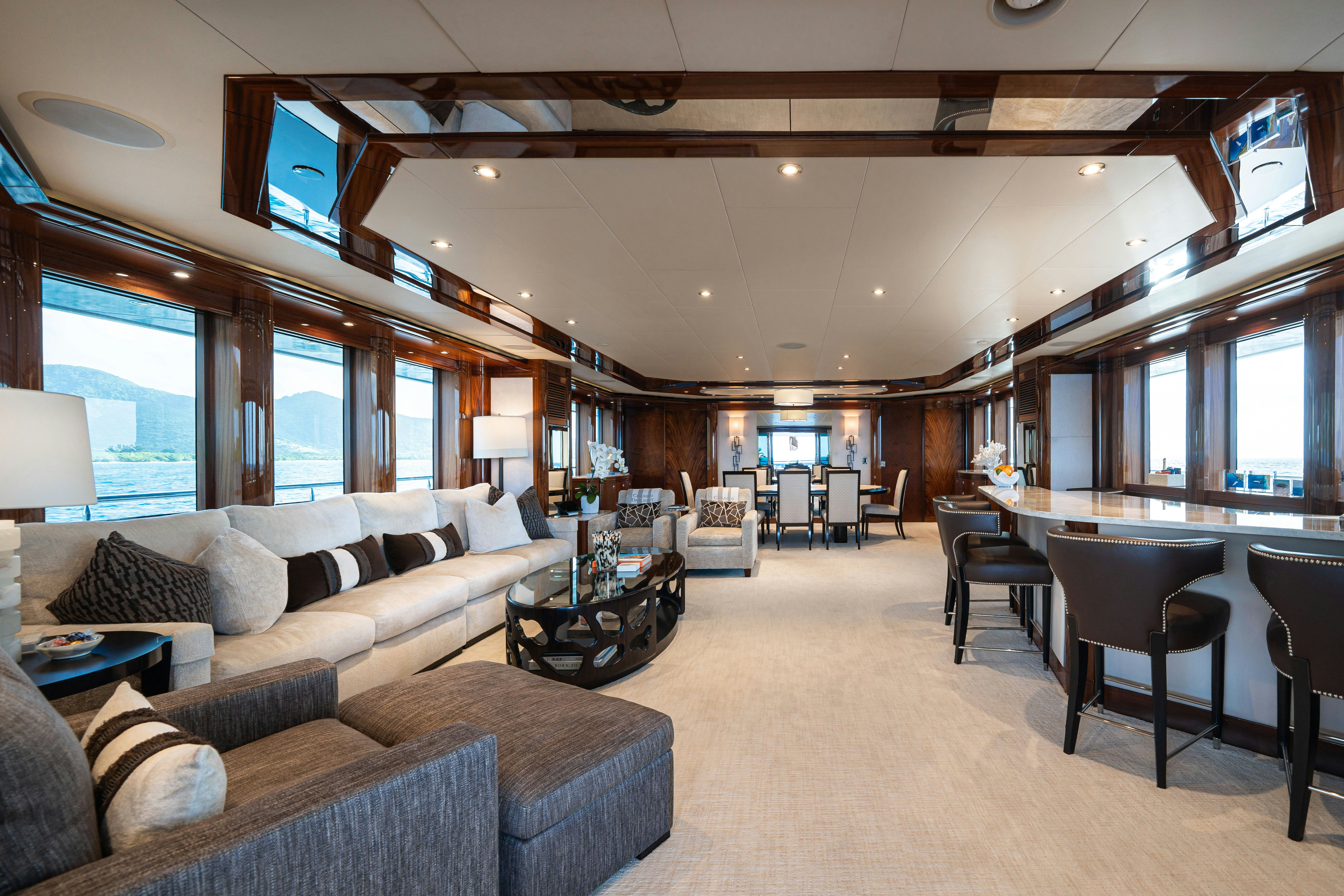 a living room with a large sofa aboard CHASING DAYLIGHT Yacht for Charter