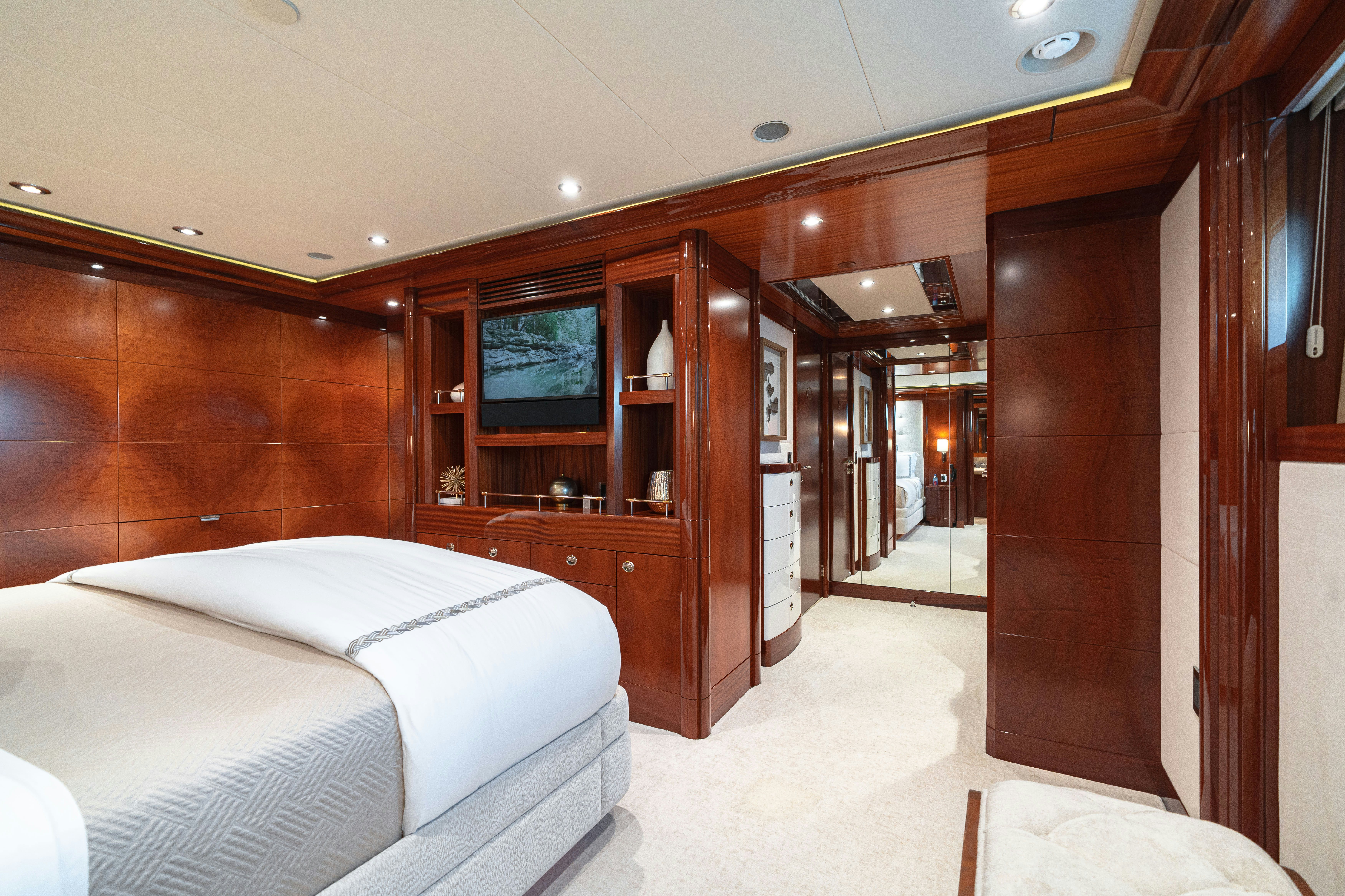 a room with a bed and a closet aboard CHASING DAYLIGHT Yacht for Charter