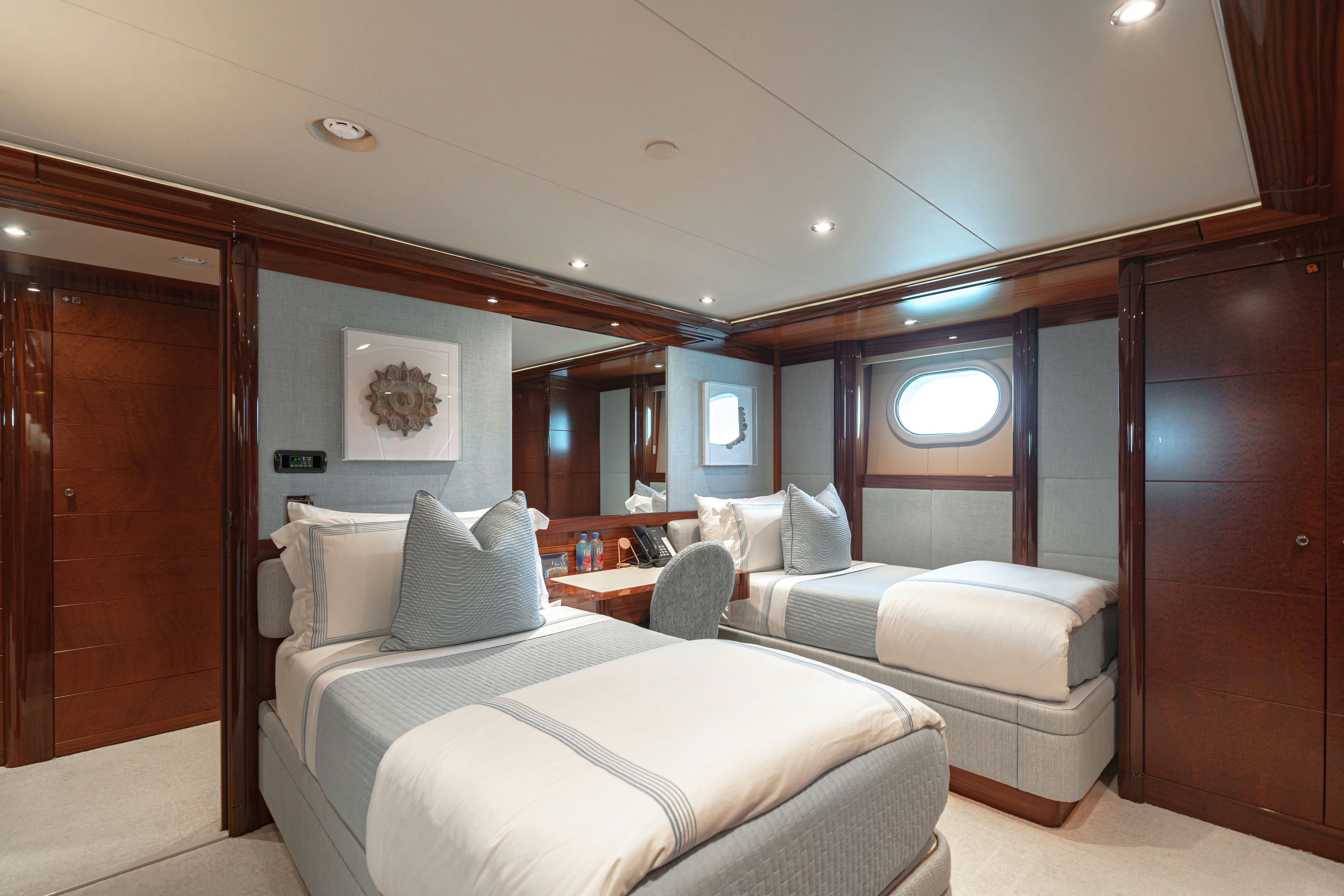 a room with a bed and a desk aboard CHASING DAYLIGHT Yacht for Charter