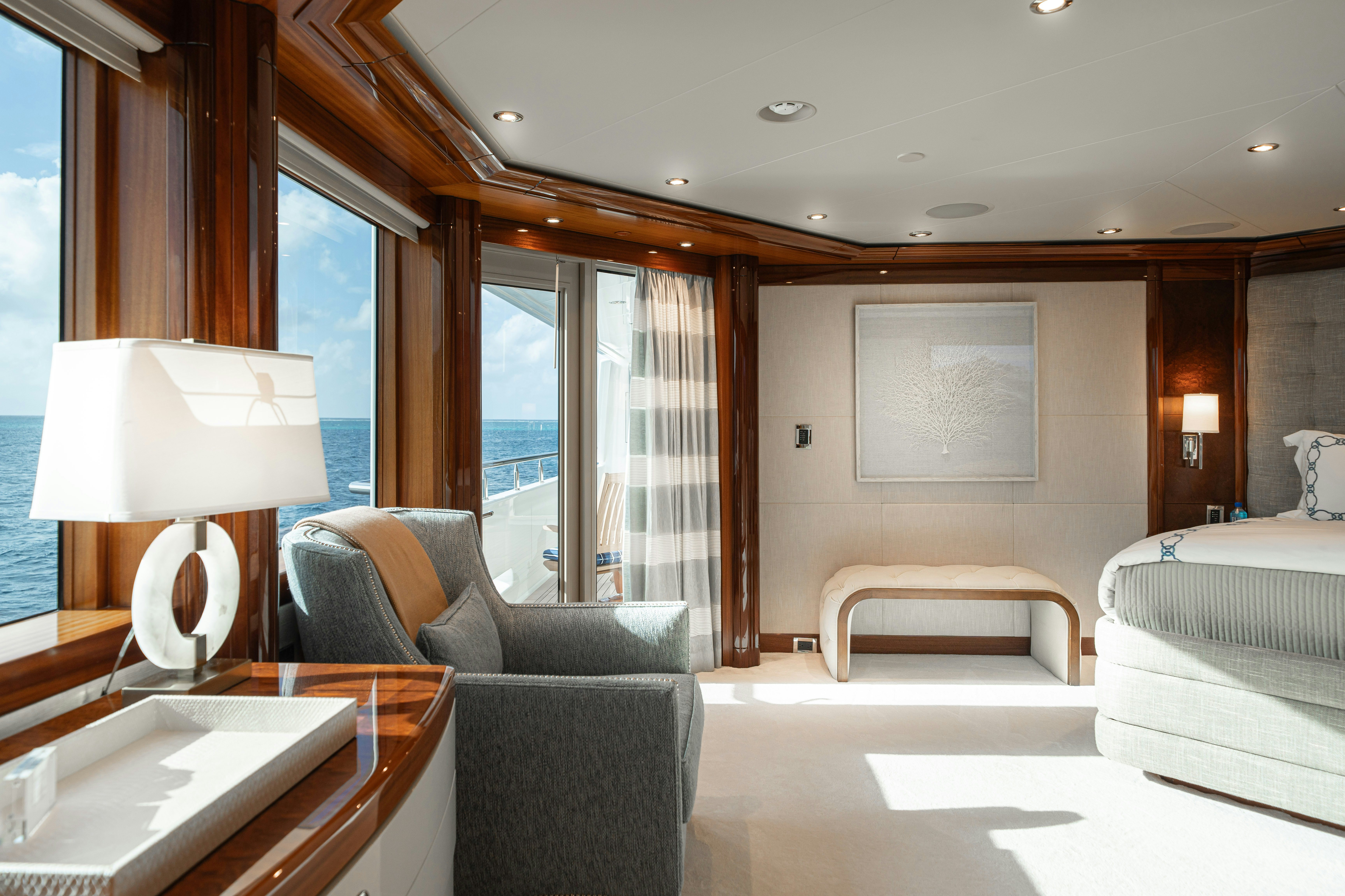 a room with a couch and a table and a lamp aboard CHASING DAYLIGHT Yacht for Charter