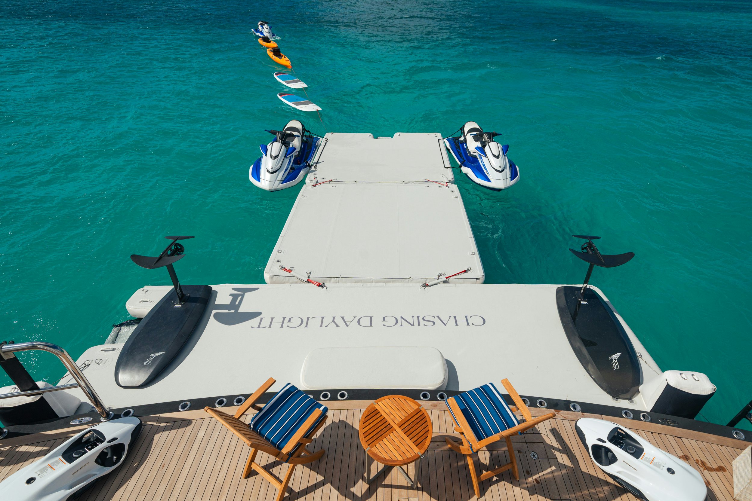 a boat with chairs on the deck aboard CHASING DAYLIGHT Yacht for Charter