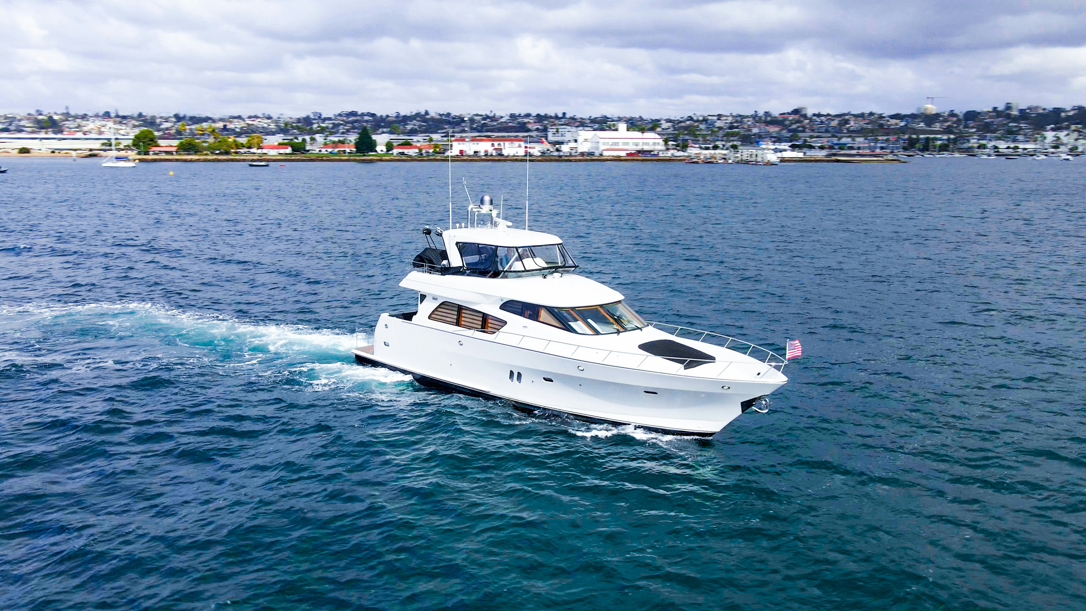 a white yacht in the water aboard YOLO Yacht for Sale