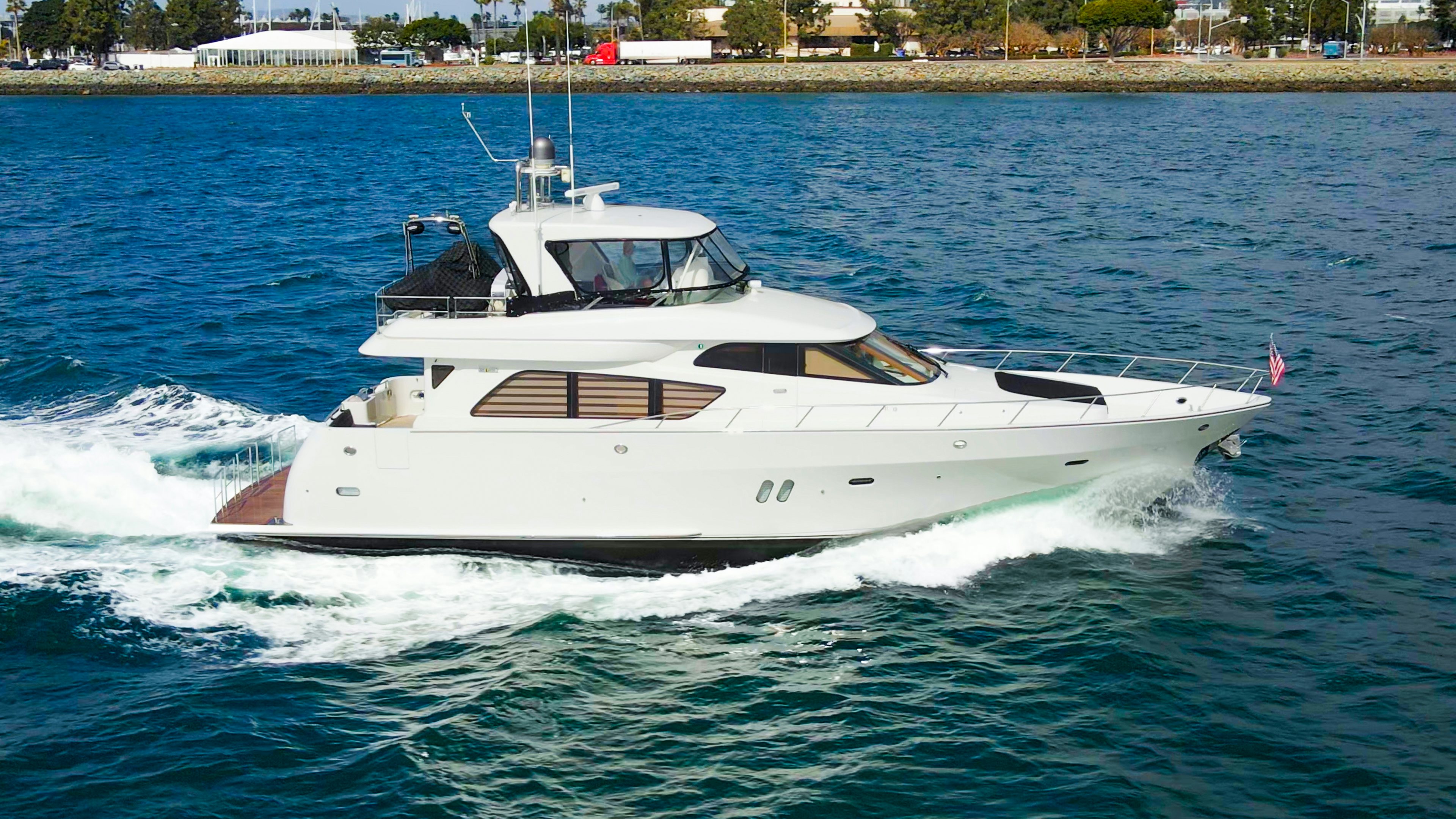 a white yacht on the water aboard YOLO Yacht for Sale