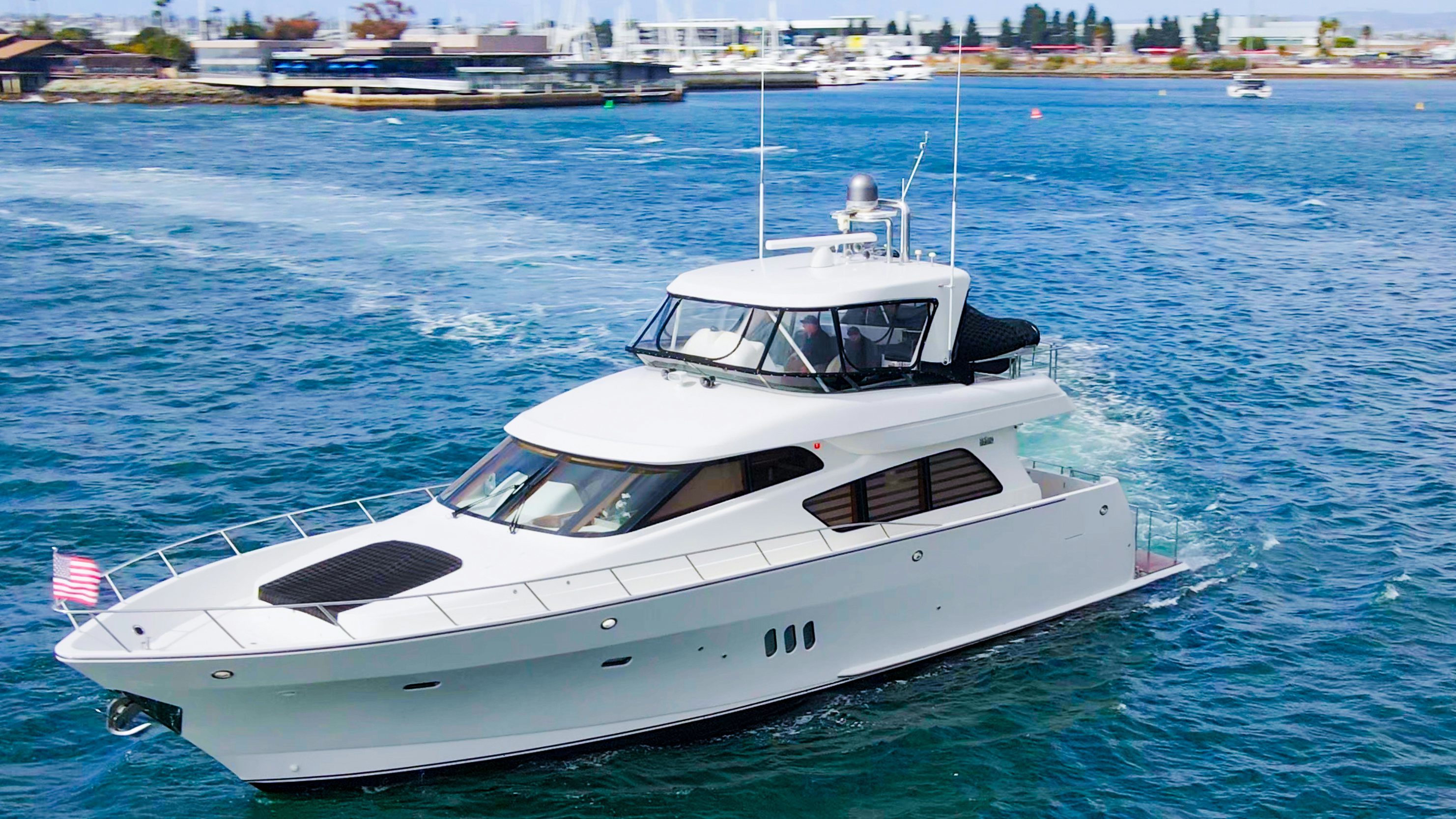 a white yacht in the water aboard YOLO Yacht for Sale