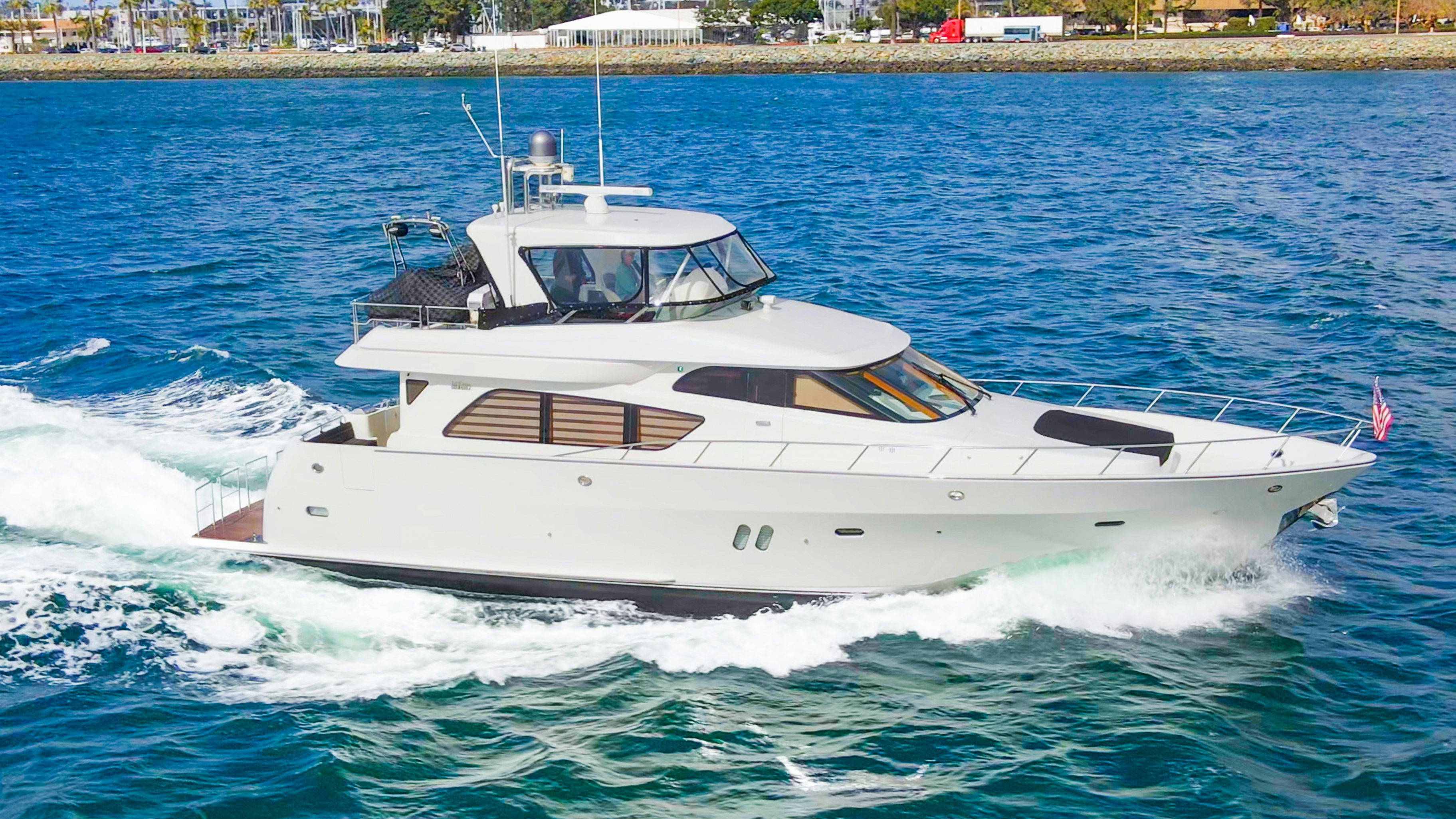 a white yacht on the water aboard YOLO Yacht for Sale