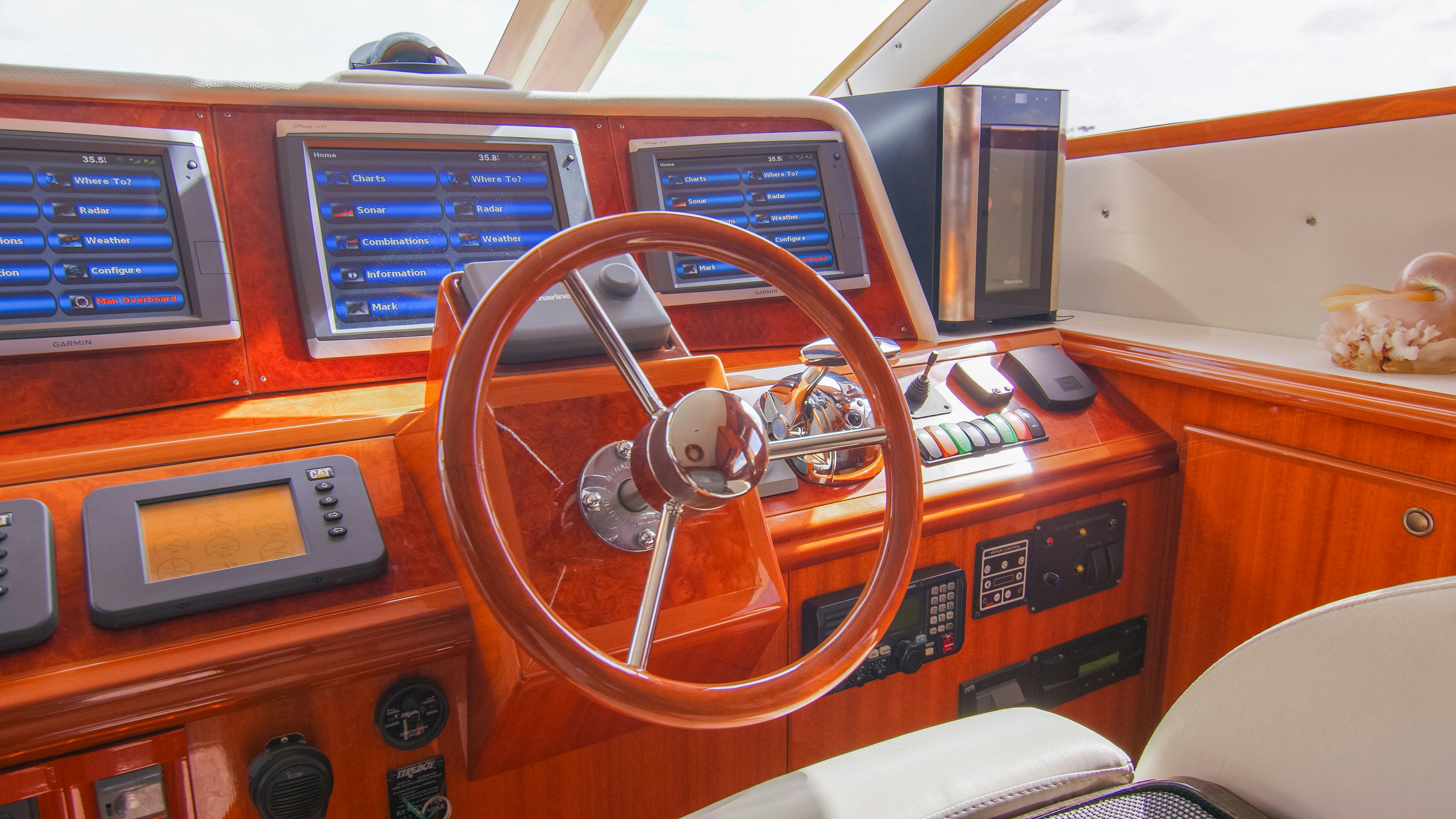 a wooden desk with a radio and other electronics aboard YOLO Yacht for Sale