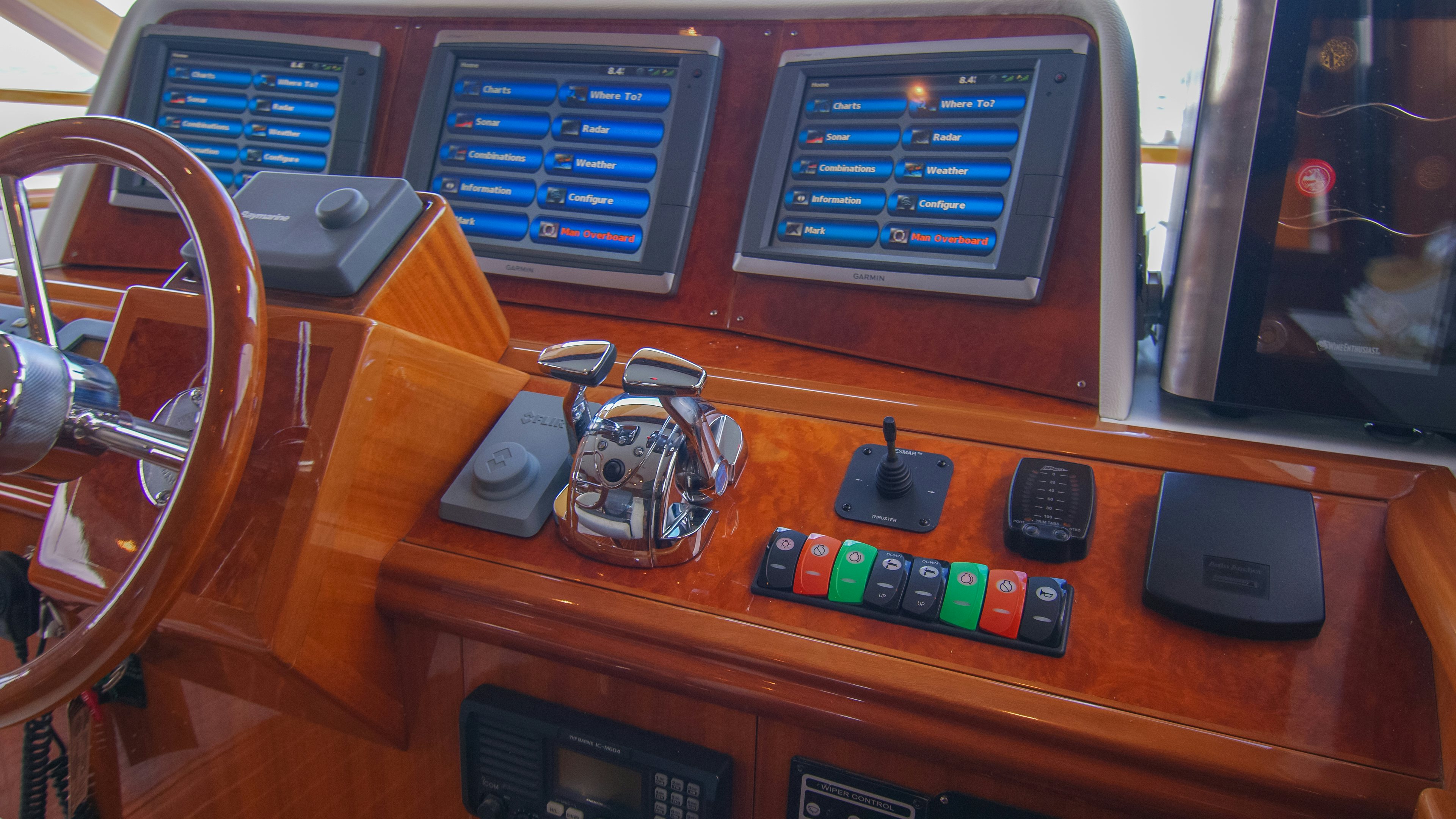 a wooden table with electronic devices aboard YOLO Yacht for Sale