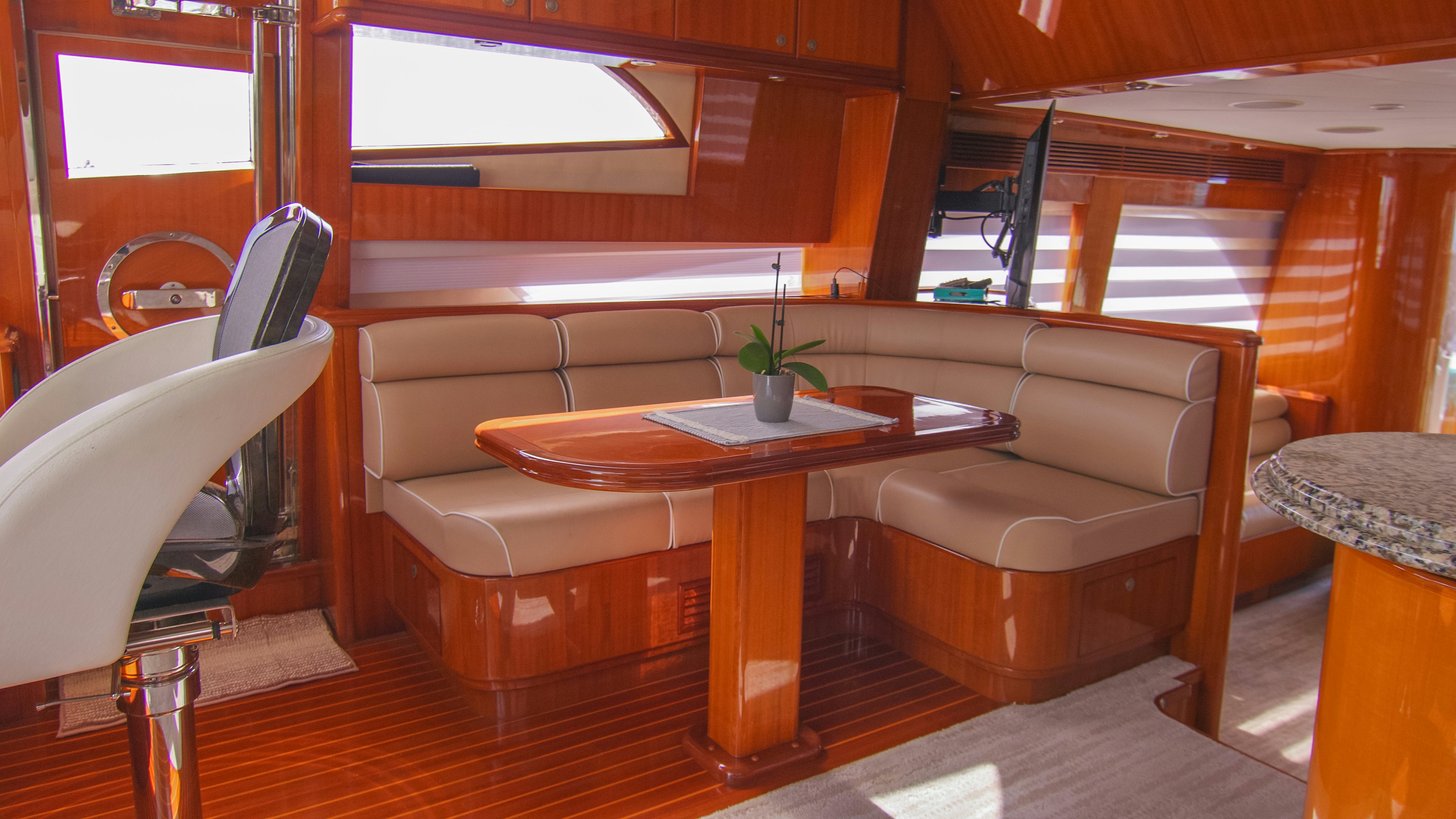 a room with a table and chairs aboard YOLO Yacht for Sale