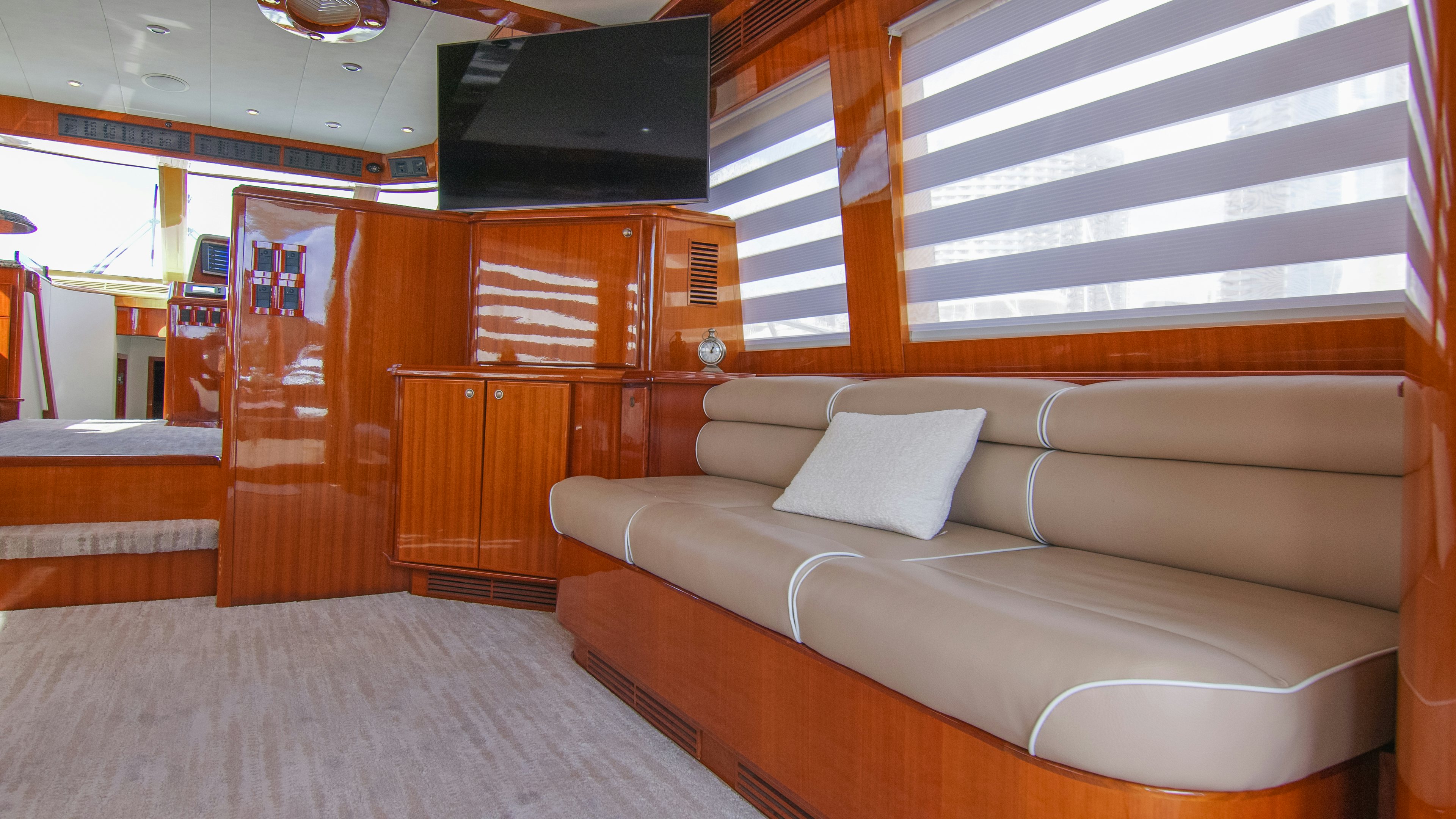 a room with a couch and a television aboard YOLO Yacht for Sale
