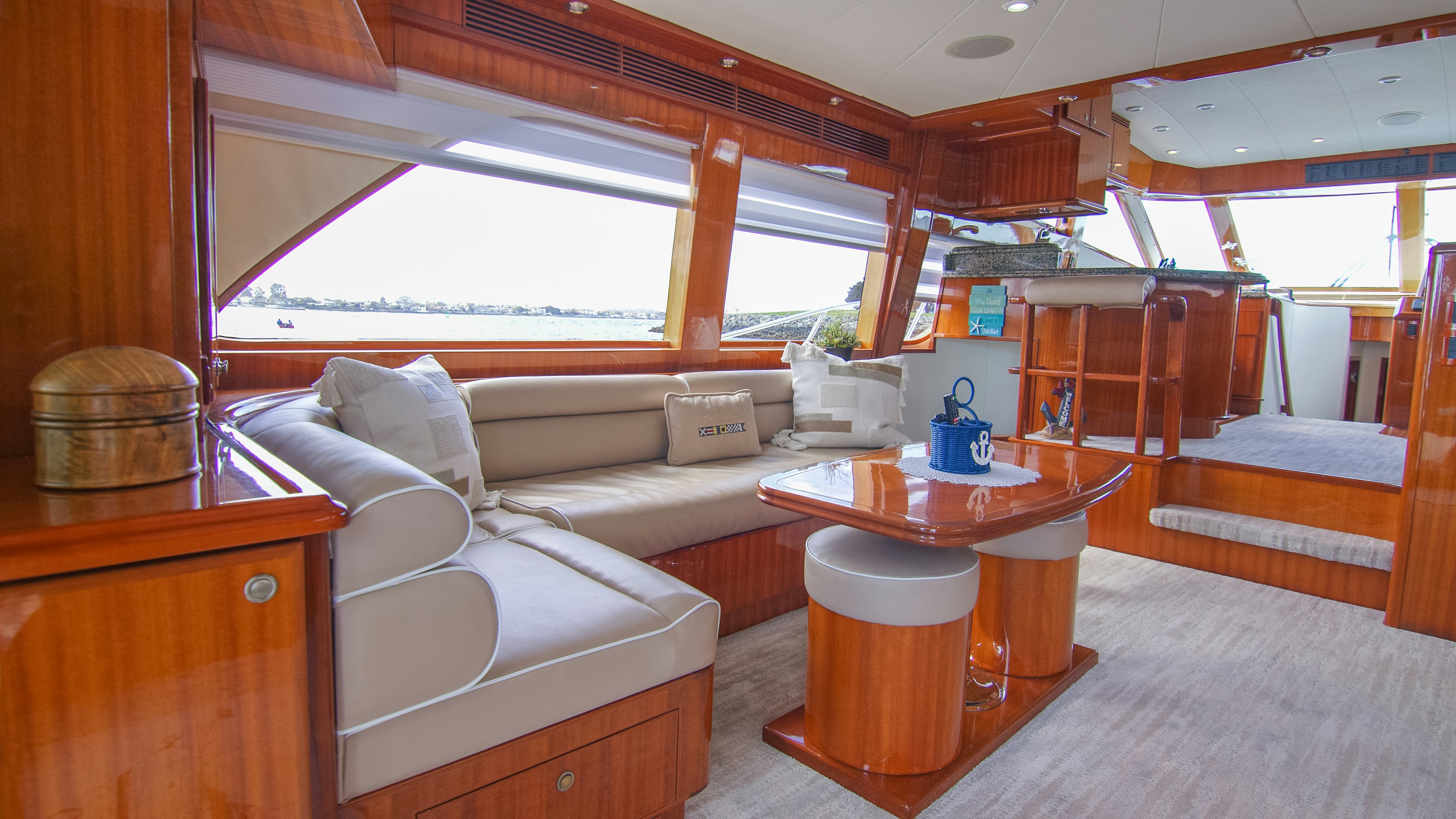 a living room with a couch and a coffee table aboard YOLO Yacht for Sale