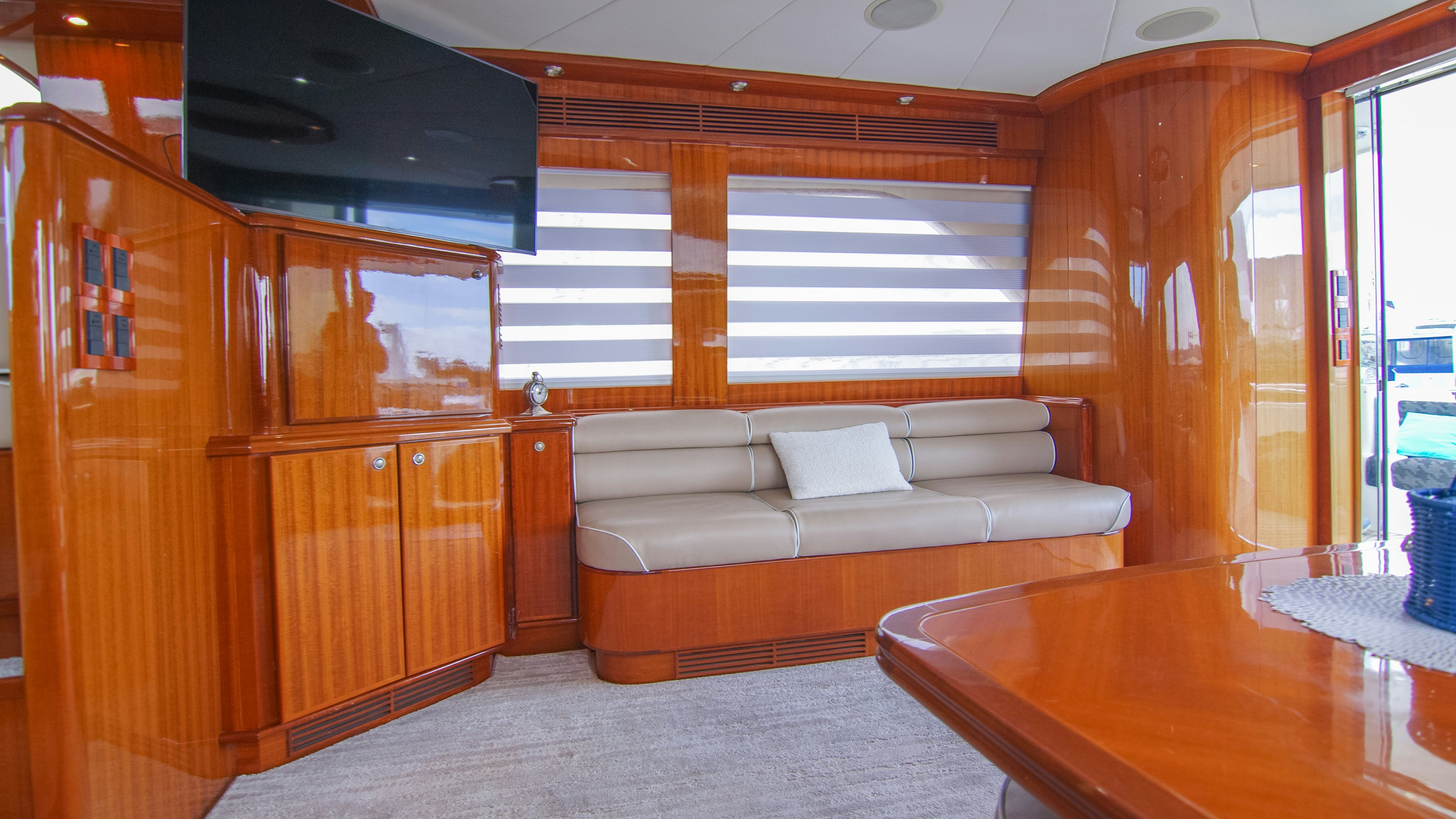 a living room with a couch and a table aboard YOLO Yacht for Sale