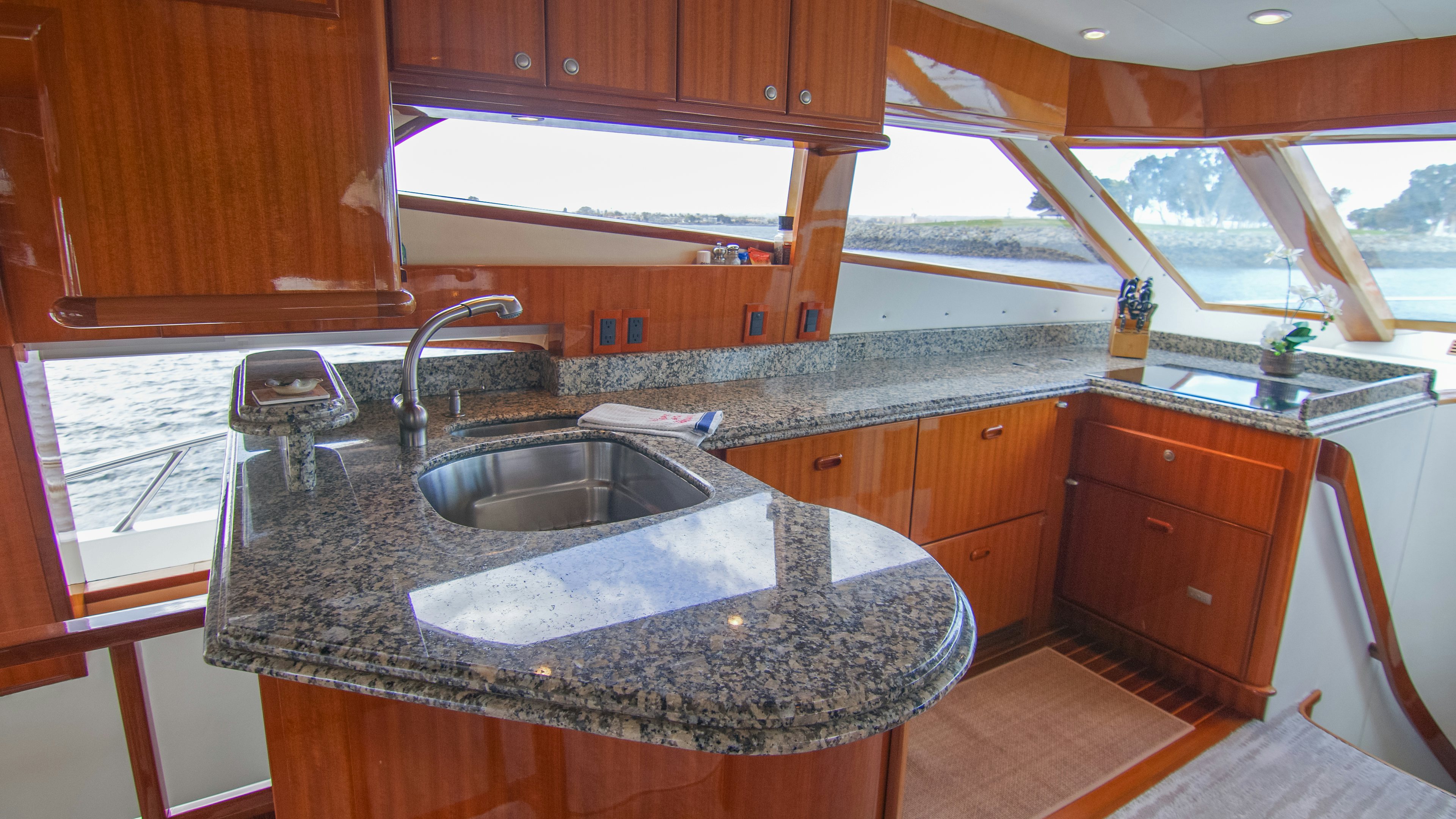 a kitchen with wooden cabinets aboard YOLO Yacht for Sale