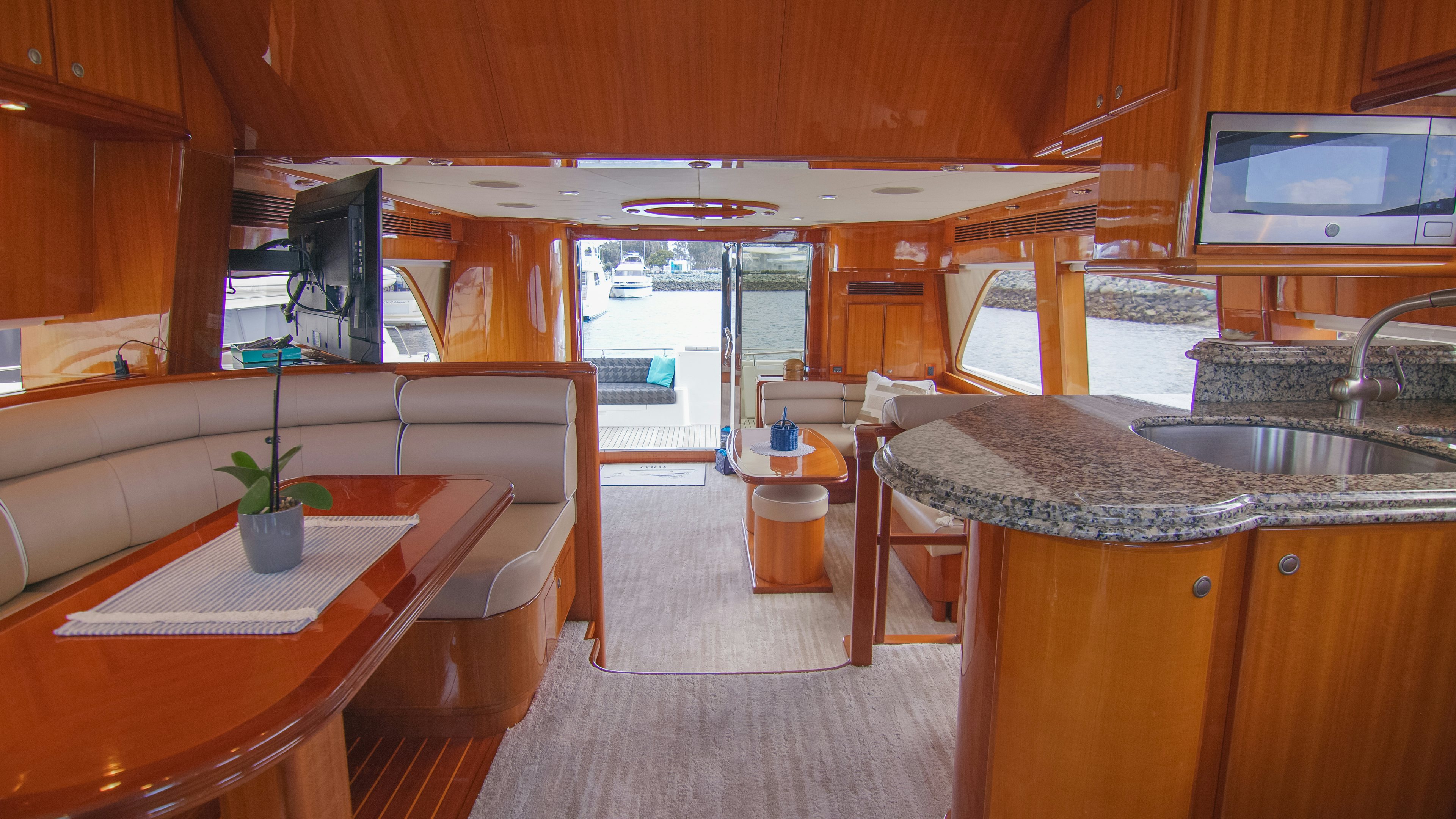 a kitchen with a table and chairs aboard YOLO Yacht for Sale