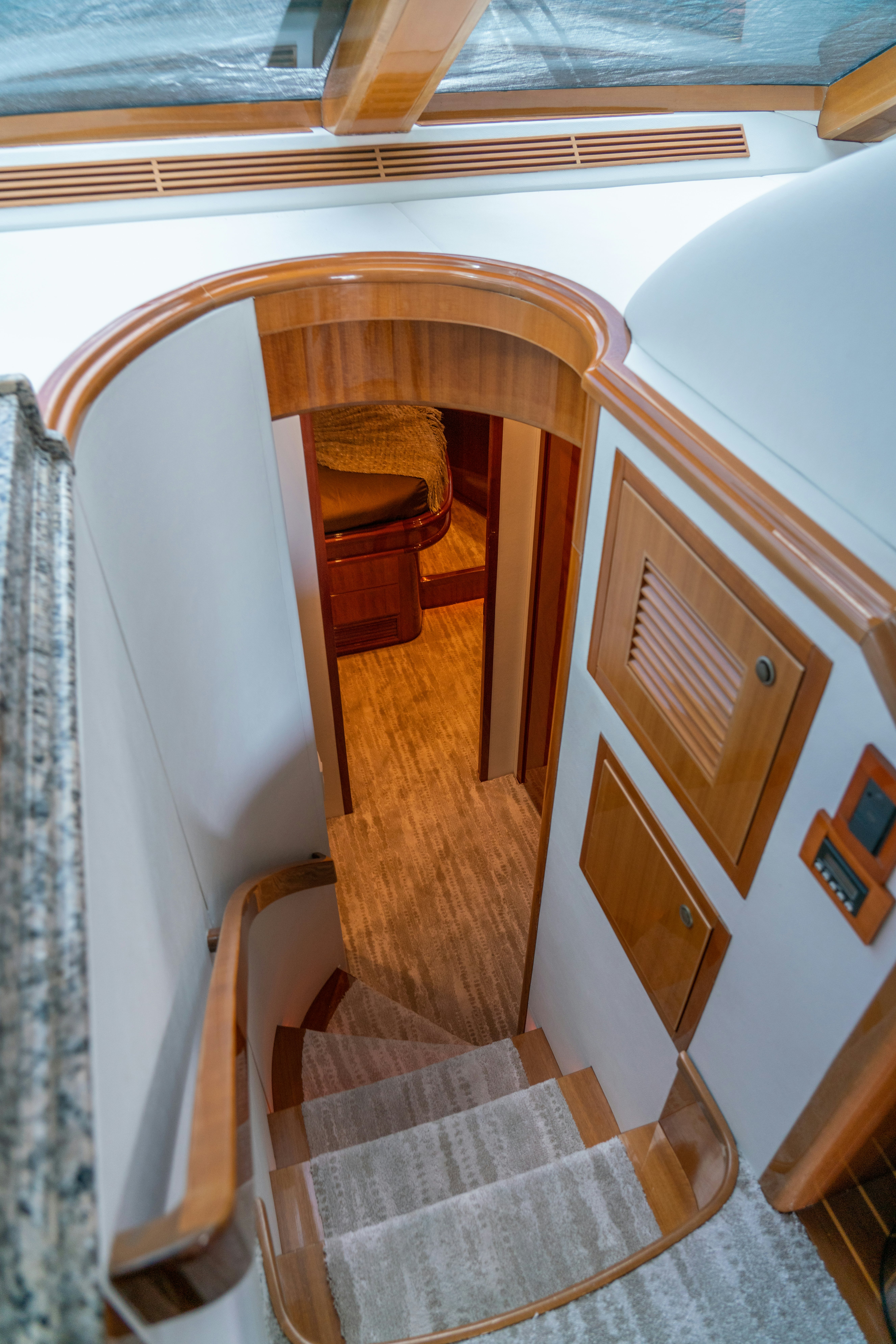 a staircase with a wood railing aboard YOLO Yacht for Sale