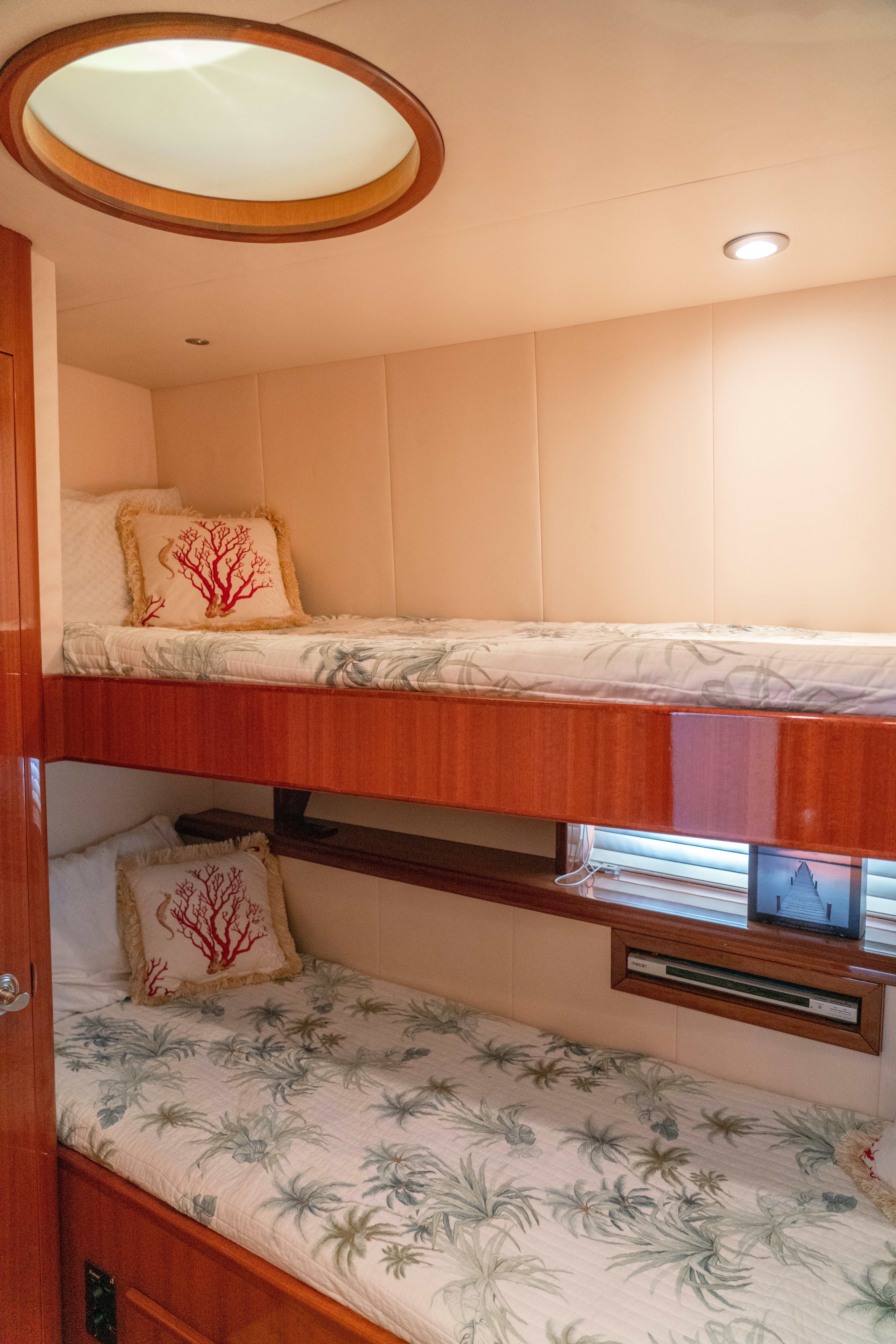 a bed with a white bed and a wooden headboard aboard YOLO Yacht for Sale