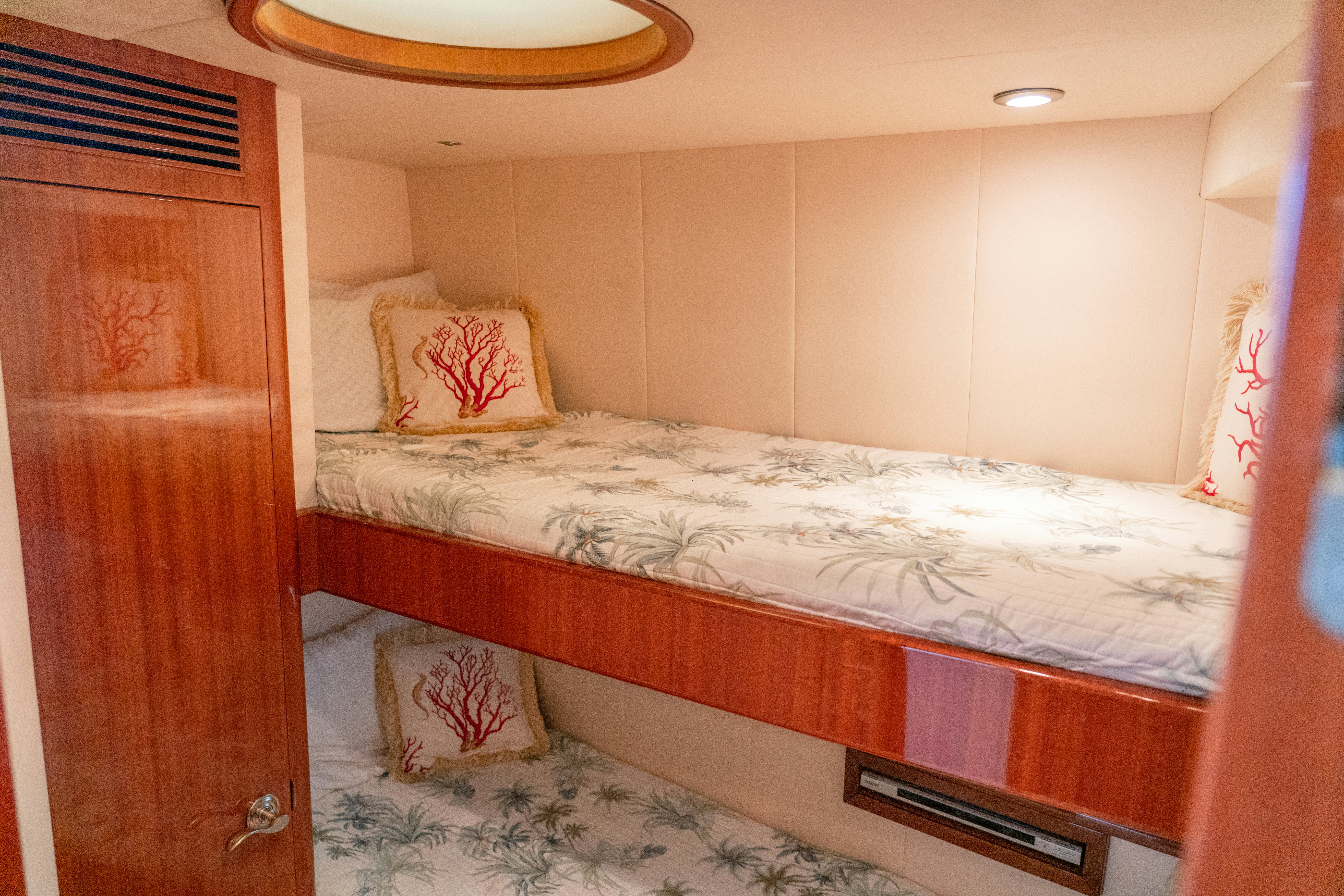 a bed with a white sheet aboard YOLO Yacht for Sale