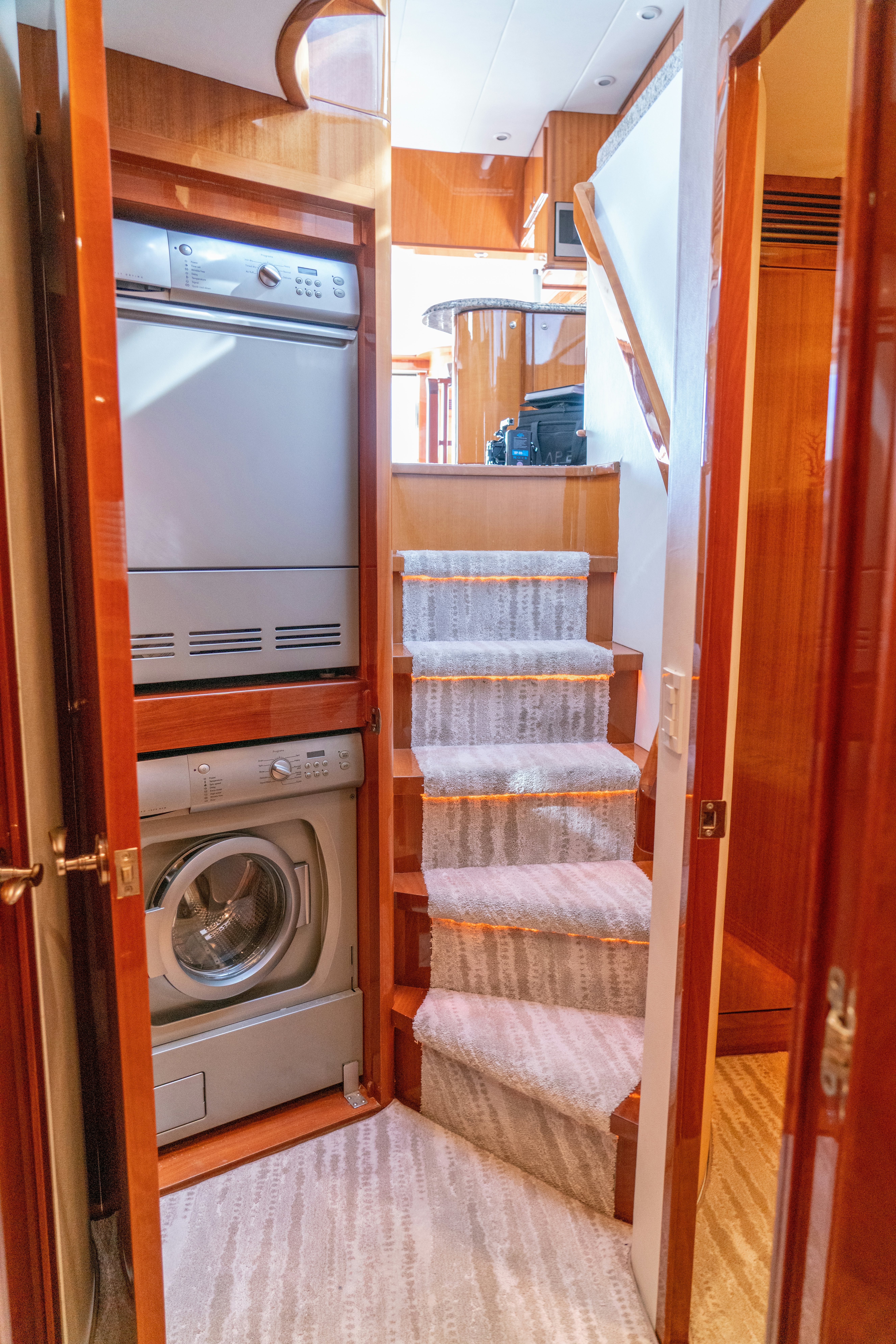a closet with clothes on the rack aboard YOLO Yacht for Sale