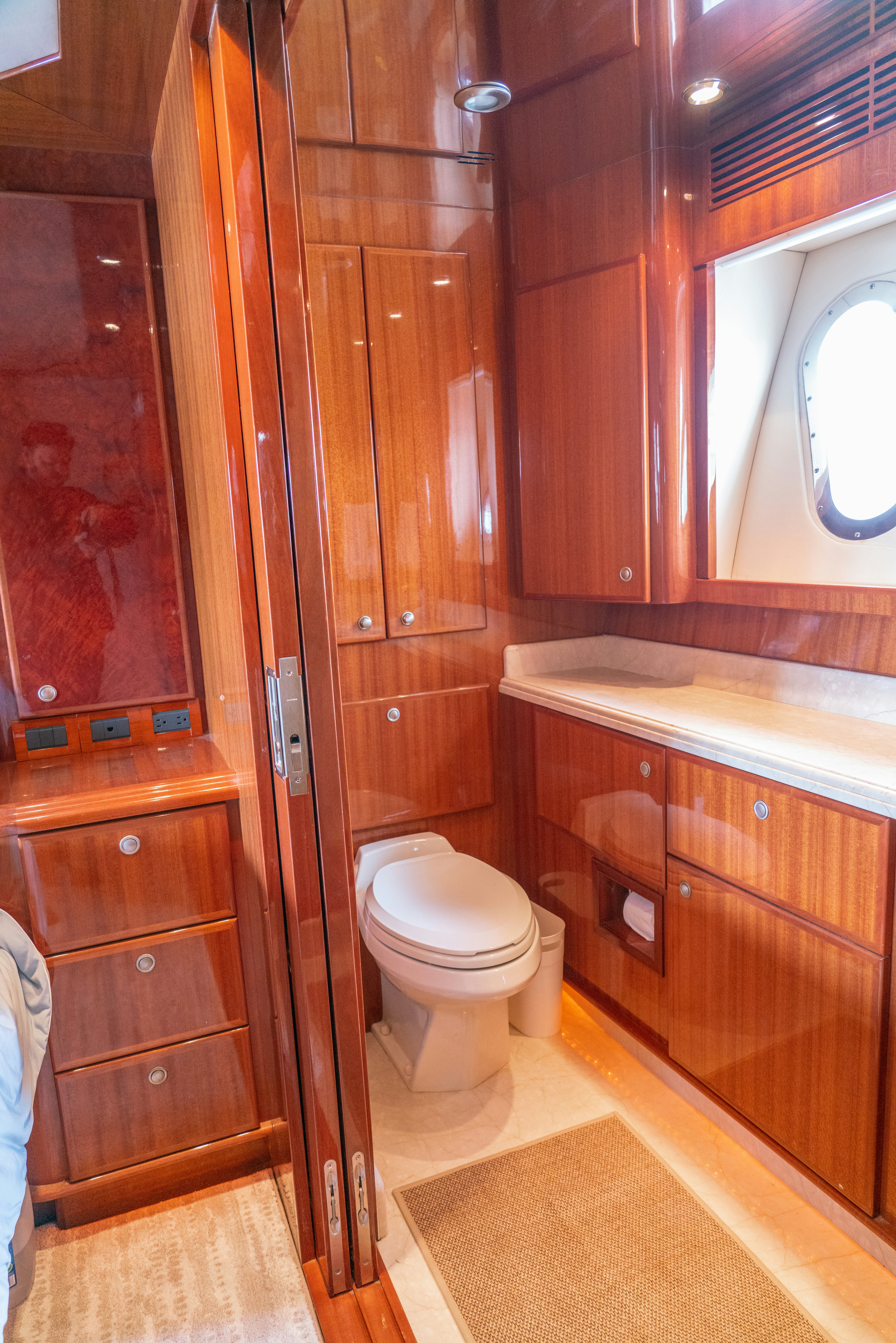 a bathroom with wooden cabinets aboard YOLO Yacht for Sale