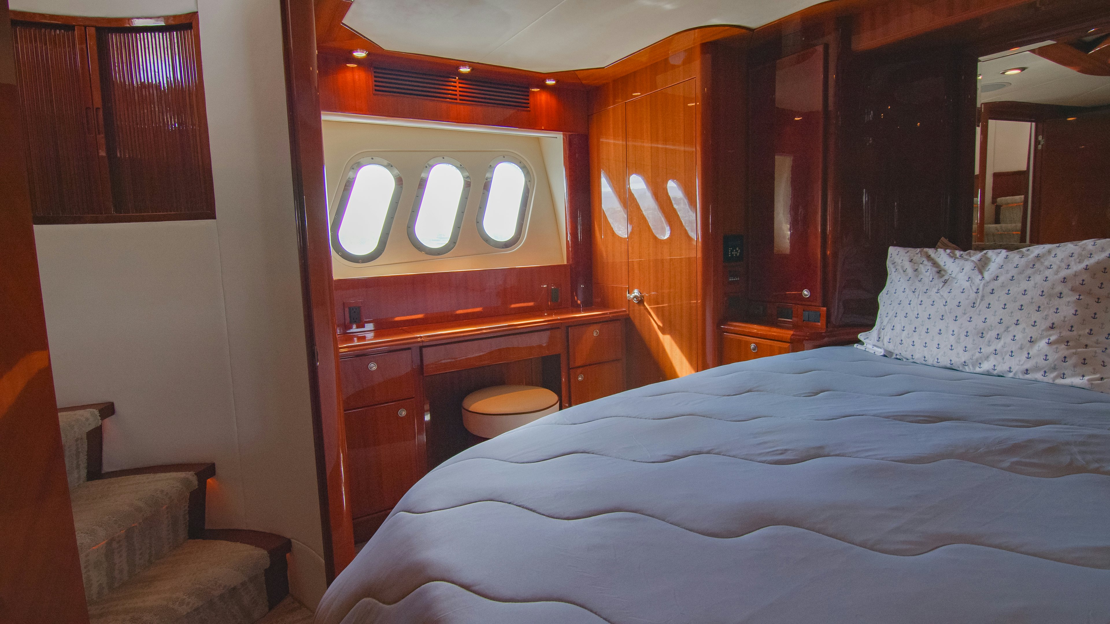 a bed with a mirror above it aboard YOLO Yacht for Sale