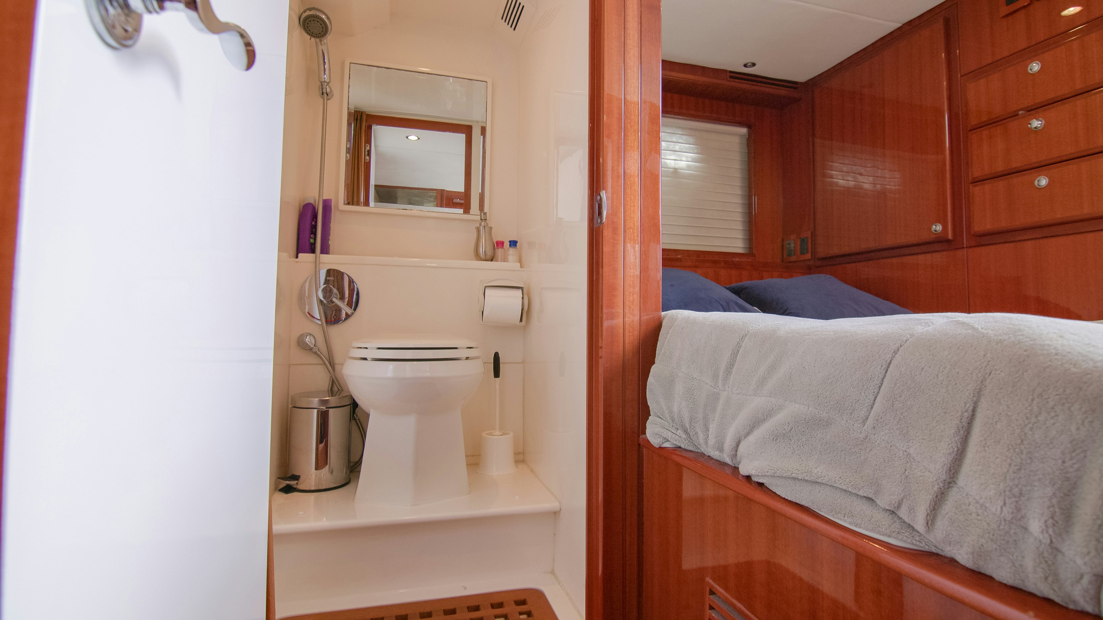 a bathroom with a toilet and a mirror aboard YOLO Yacht for Sale