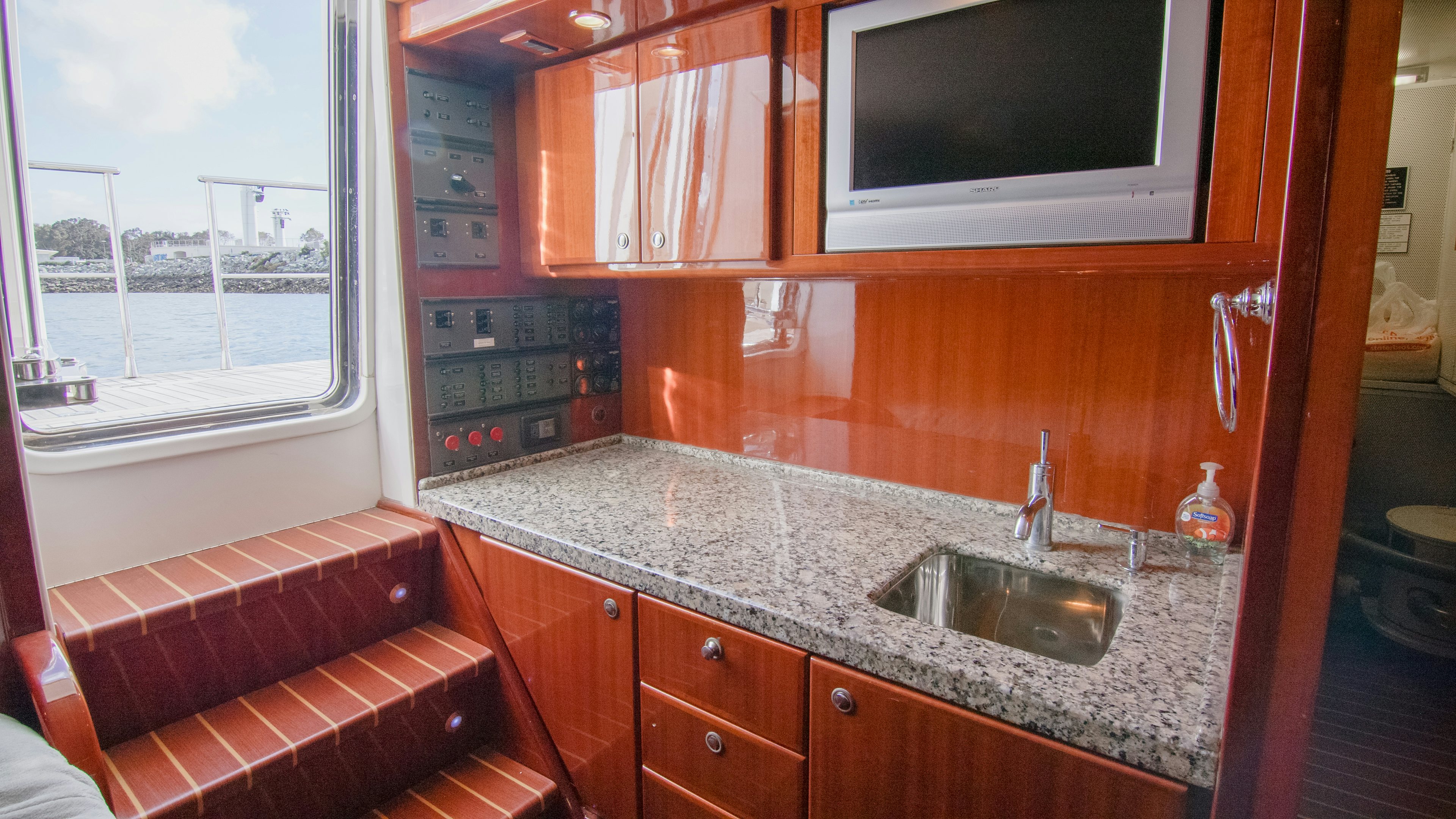 a kitchen with a sink and microwave aboard YOLO Yacht for Sale