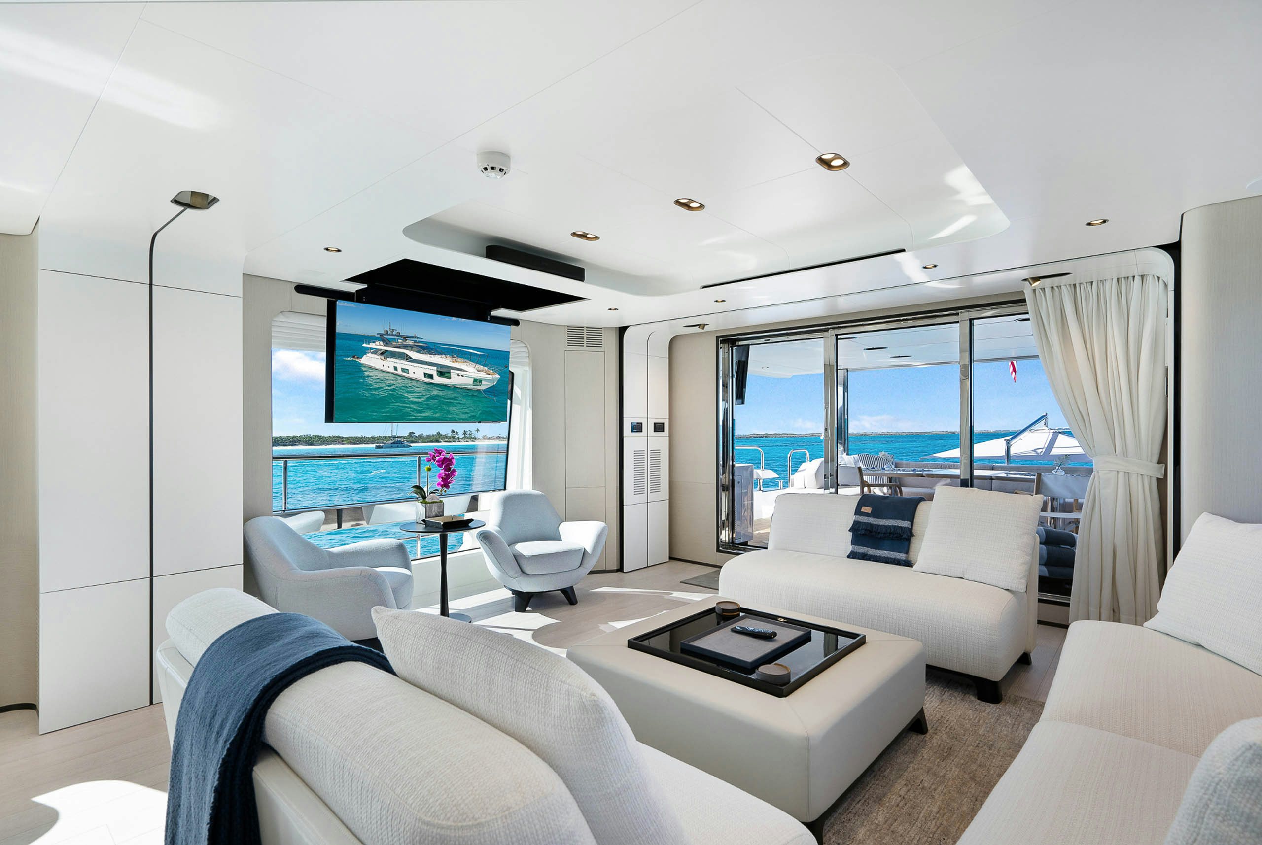 a living room with a large screen aboard SEA OWL Yacht for Charter