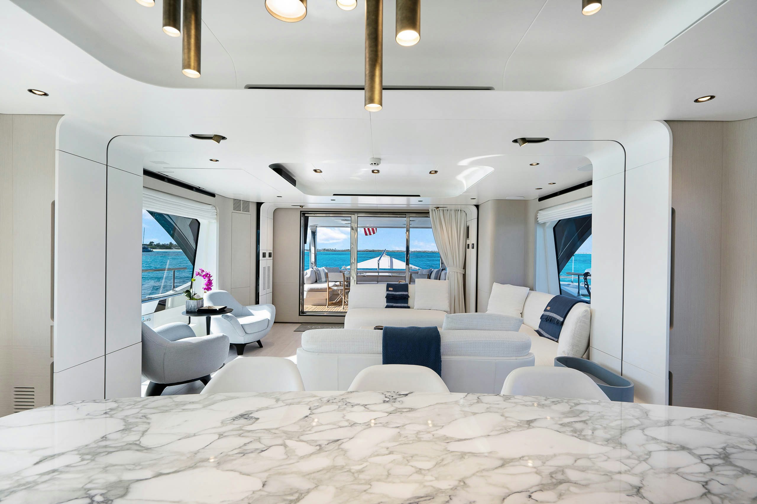 a large white room with a large bed and a large window aboard SEA OWL Yacht for Charter