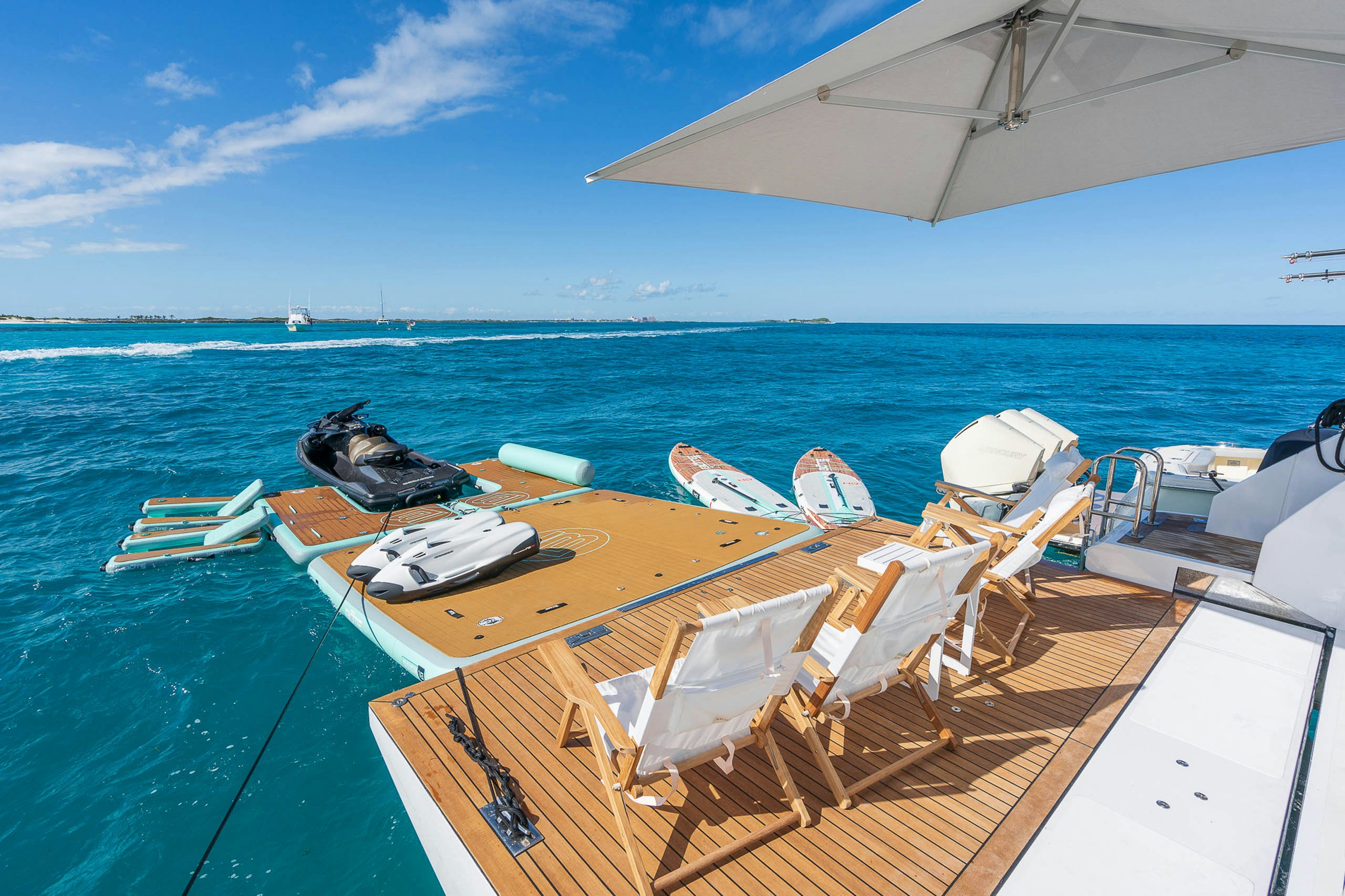 a deck with chairs and boats on it by the water aboard SEA OWL Yacht for Charter