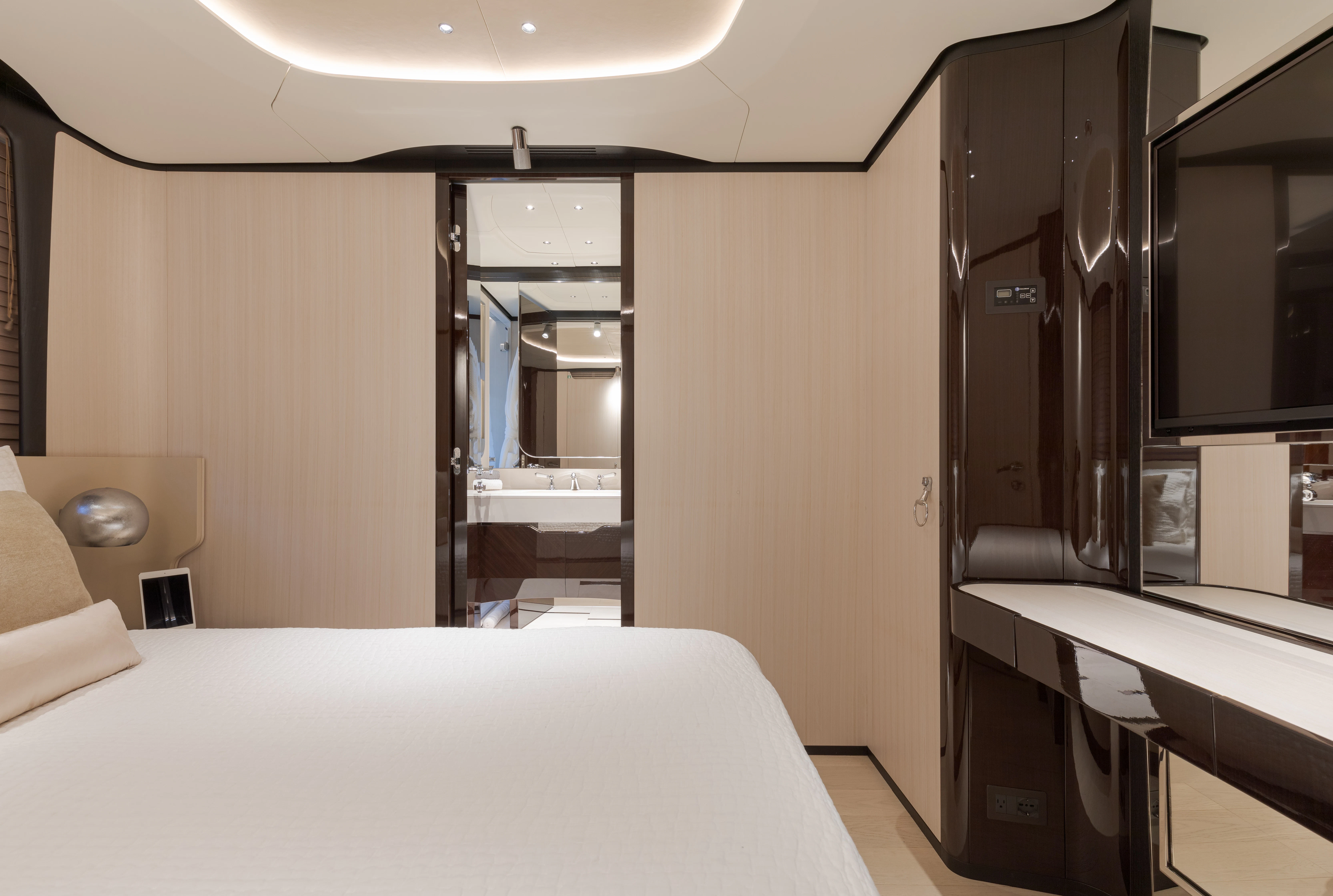 a room with a bed and desk aboard BELLA VITA Yacht for Charter