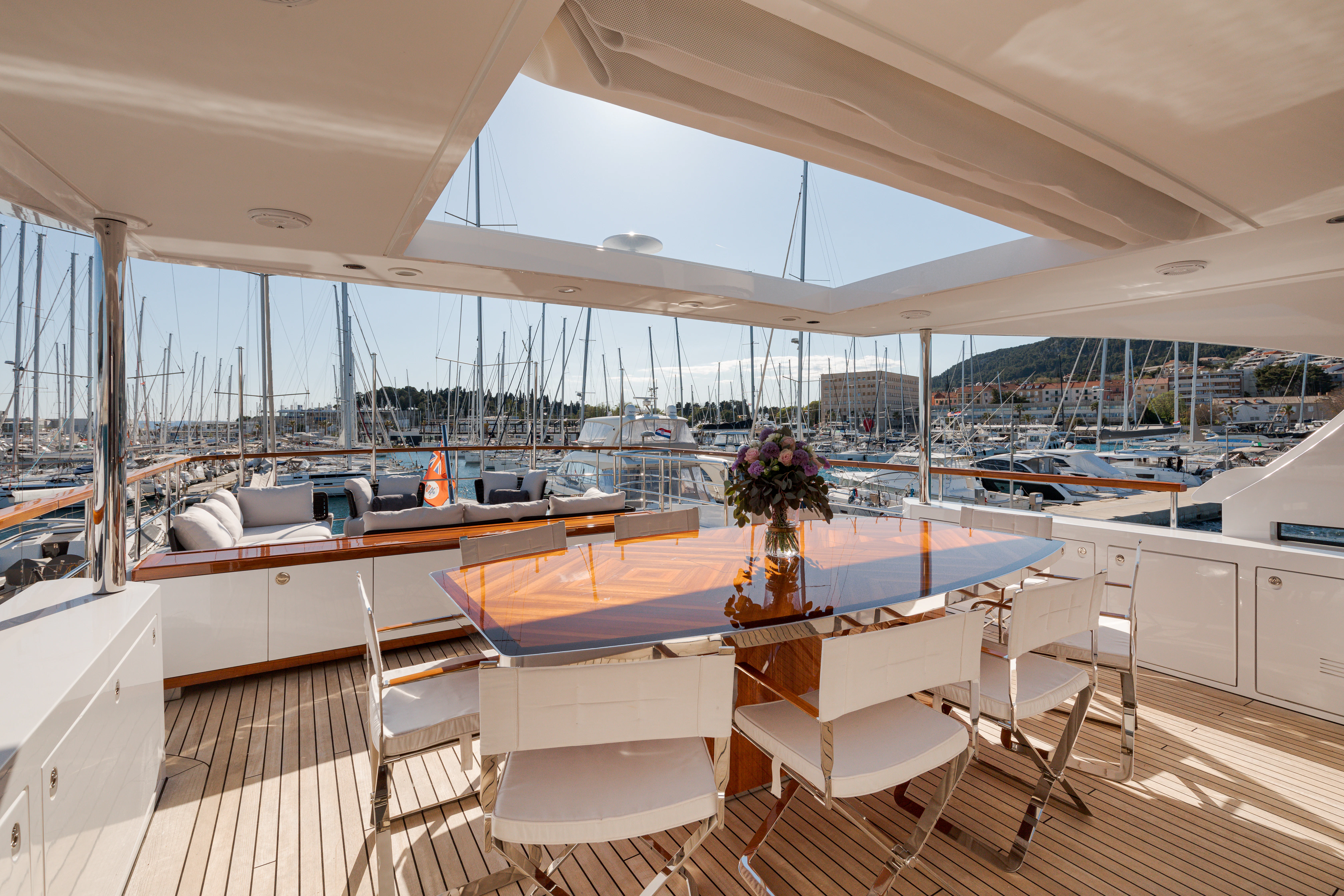 a boat with a table and chairs aboard BELLA VITA Yacht for Charter
