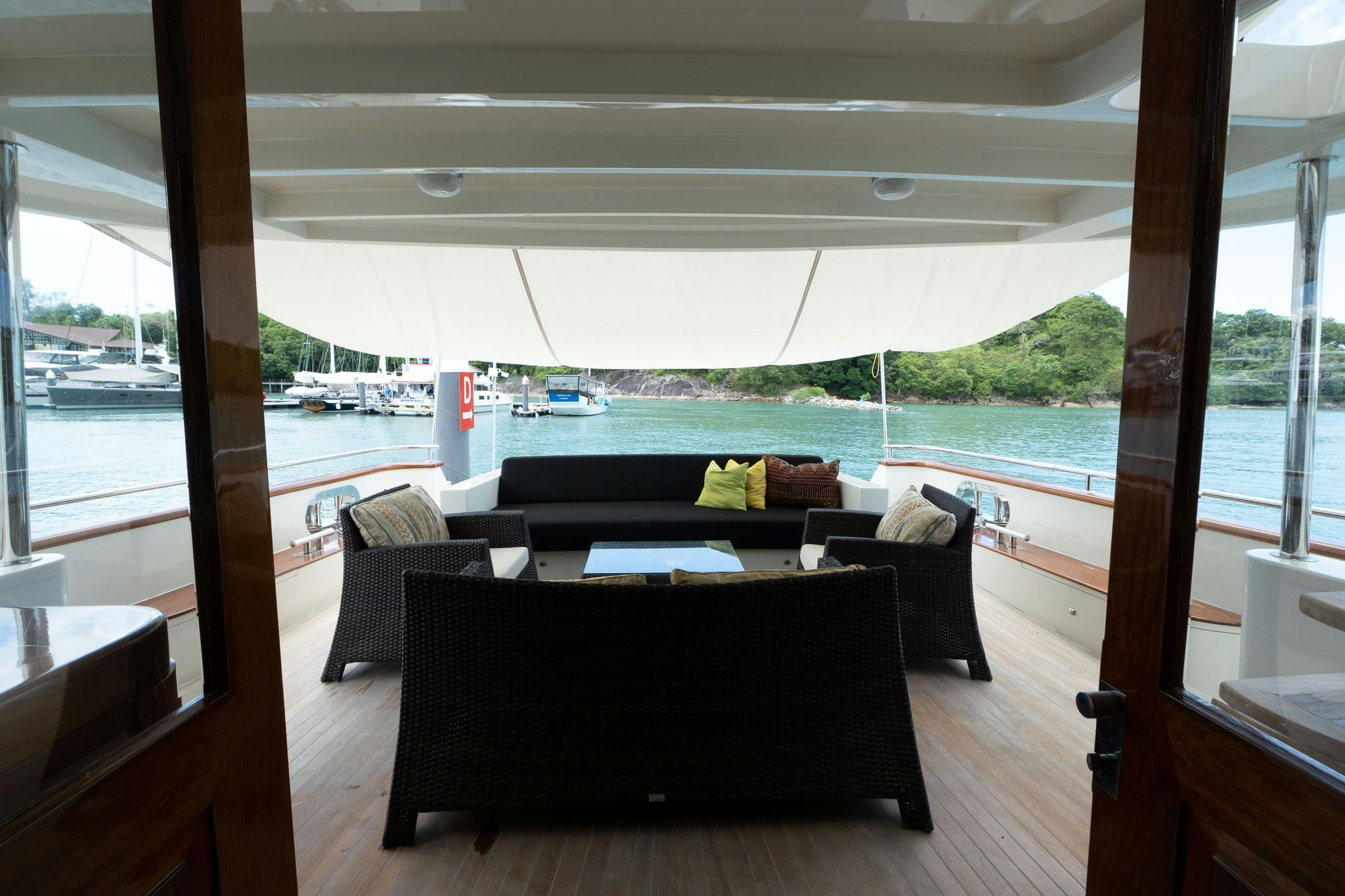 a room with a view of the water and boats aboard THEA Yacht for Sale